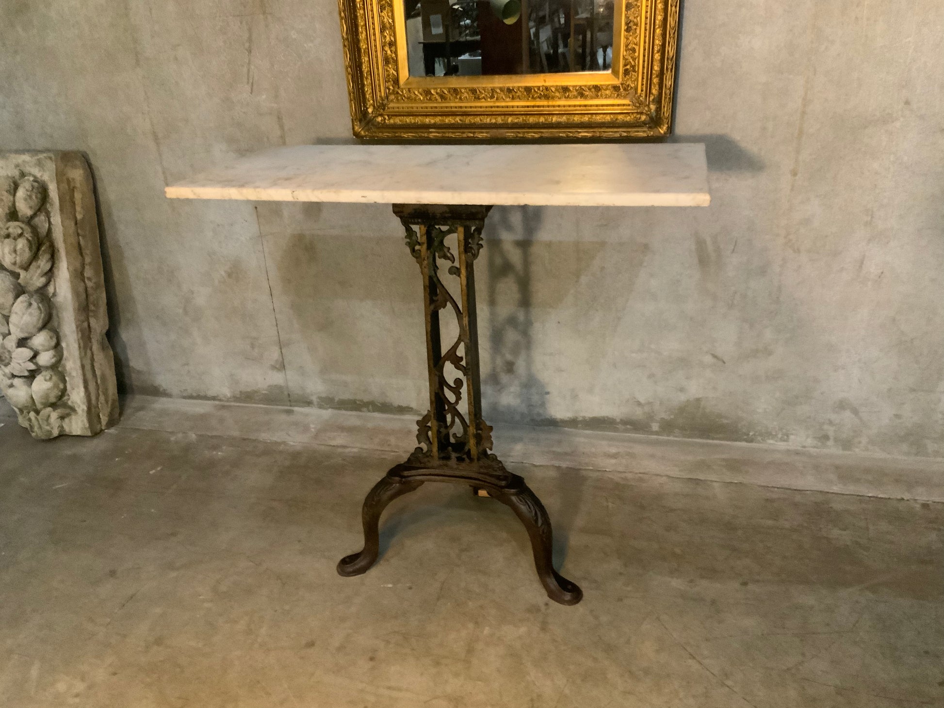 C 1900 cast iron detailed table base with marble top | Scott Landon Antiques and Interiors.