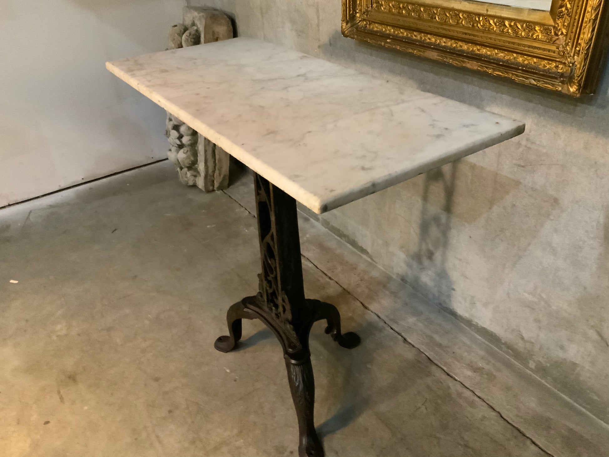 C 1900 cast iron detailed table base with marble top | Scott Landon Antiques and Interiors.