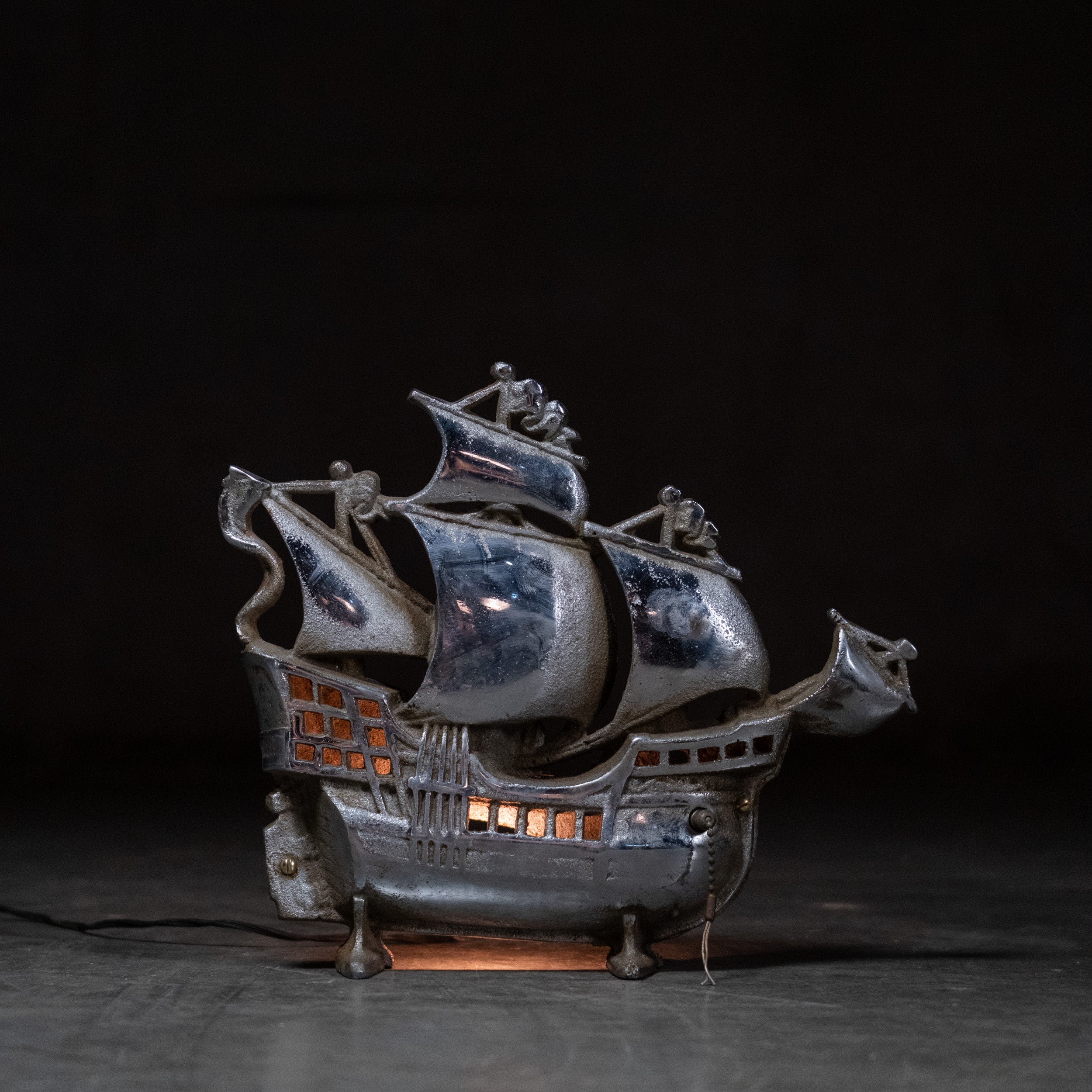Primary: Vintage 1930s cast metal Spanish galleon ship accent lamp illuminated | Scott Landon Antiques and Interiors.