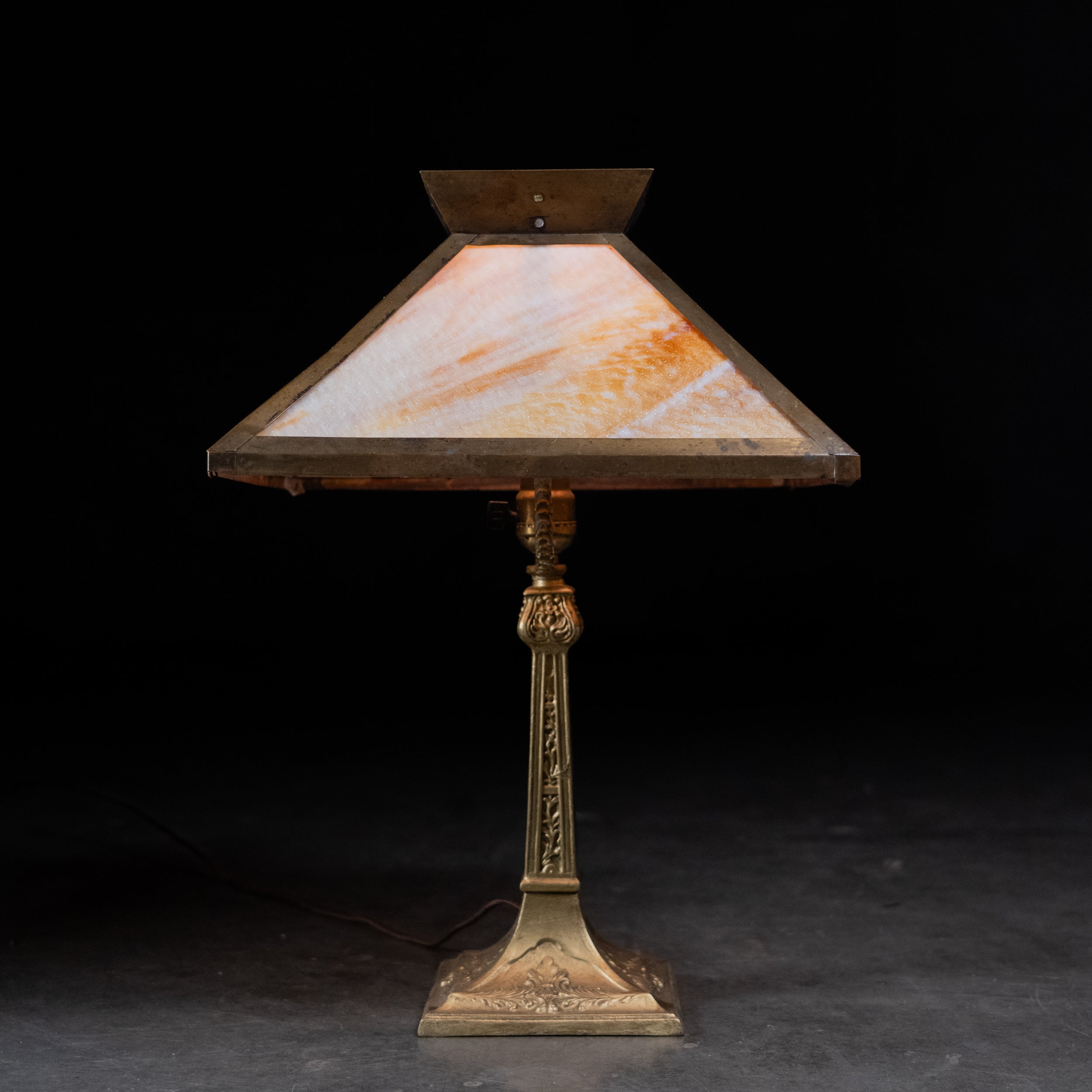 Antique c. 1920 slag glass table lamp with amber cream glass shade and ornate cast metal base