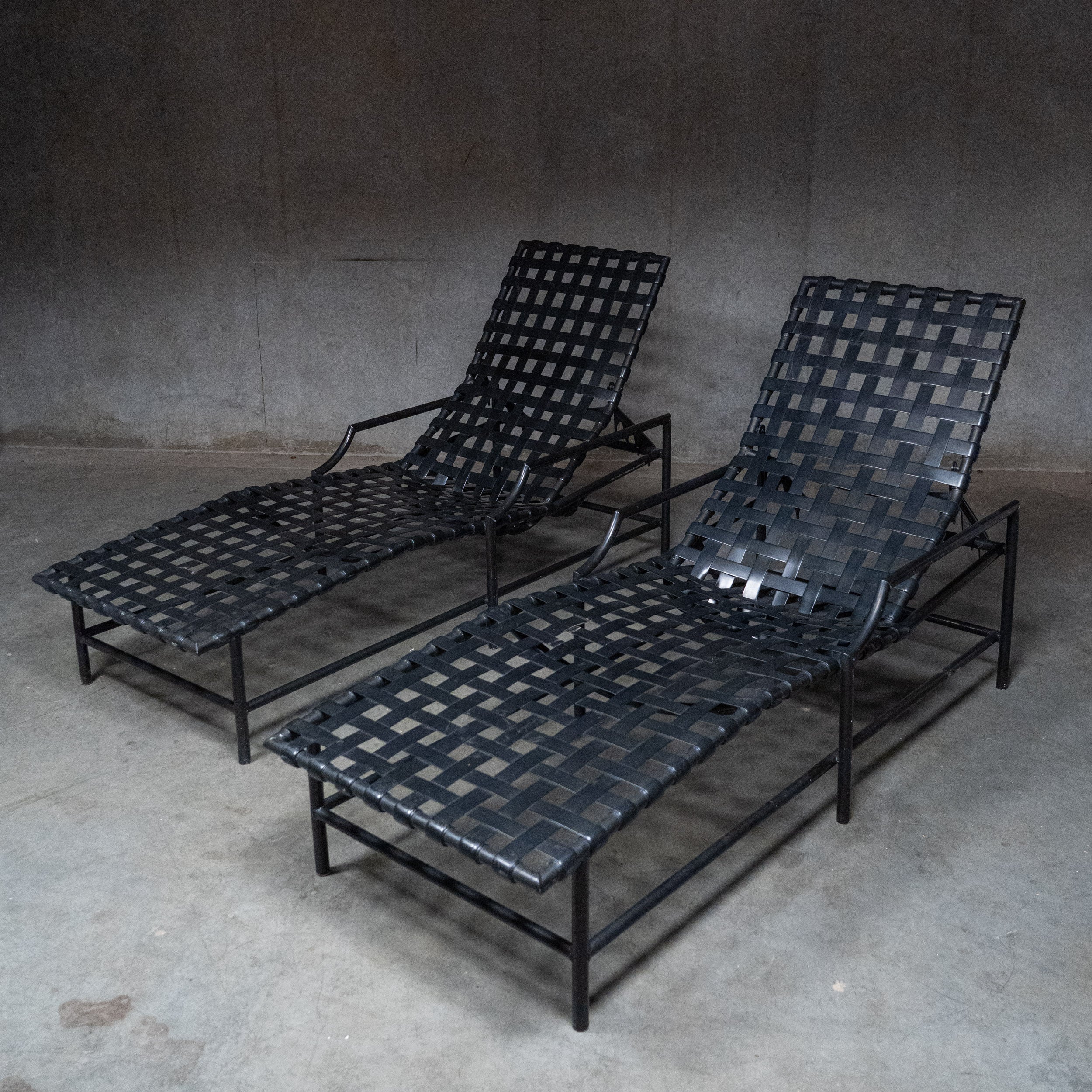  Pair of vintage Tropitone adjustable chaise lounges with black woven basket-weave strapping and metal frames. | Scott Landon Antiques and Interiors.