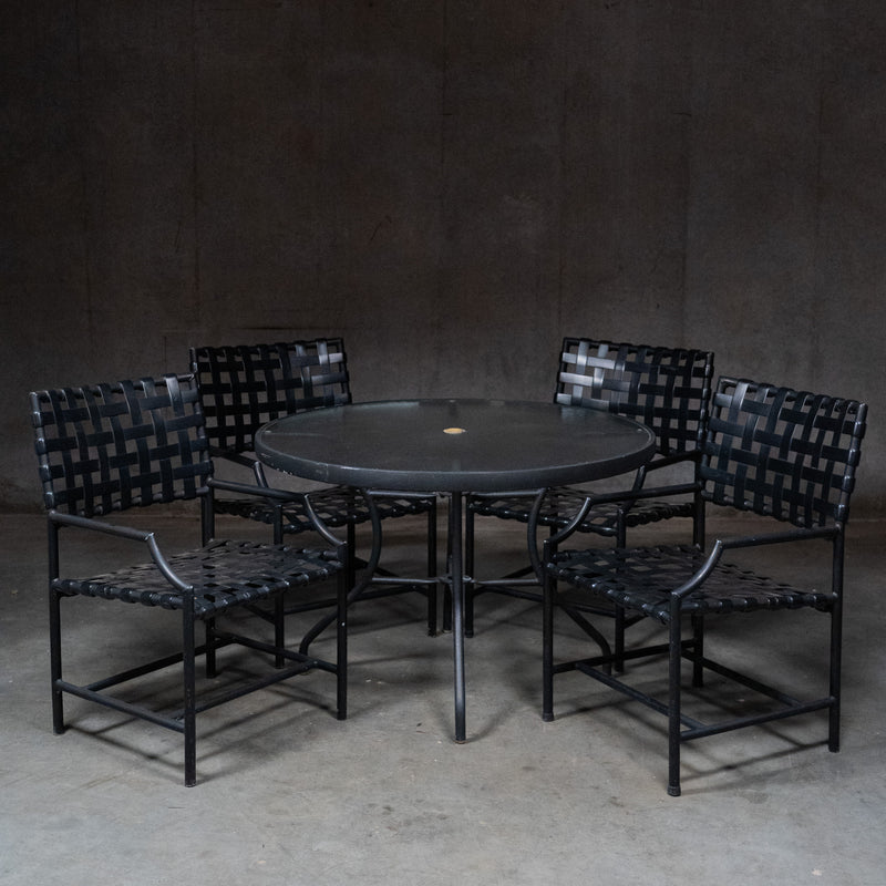  Vintage Tropitone black patio dining set with round table and four woven strap armchairs | Scott Landon Antiques and Interiors.