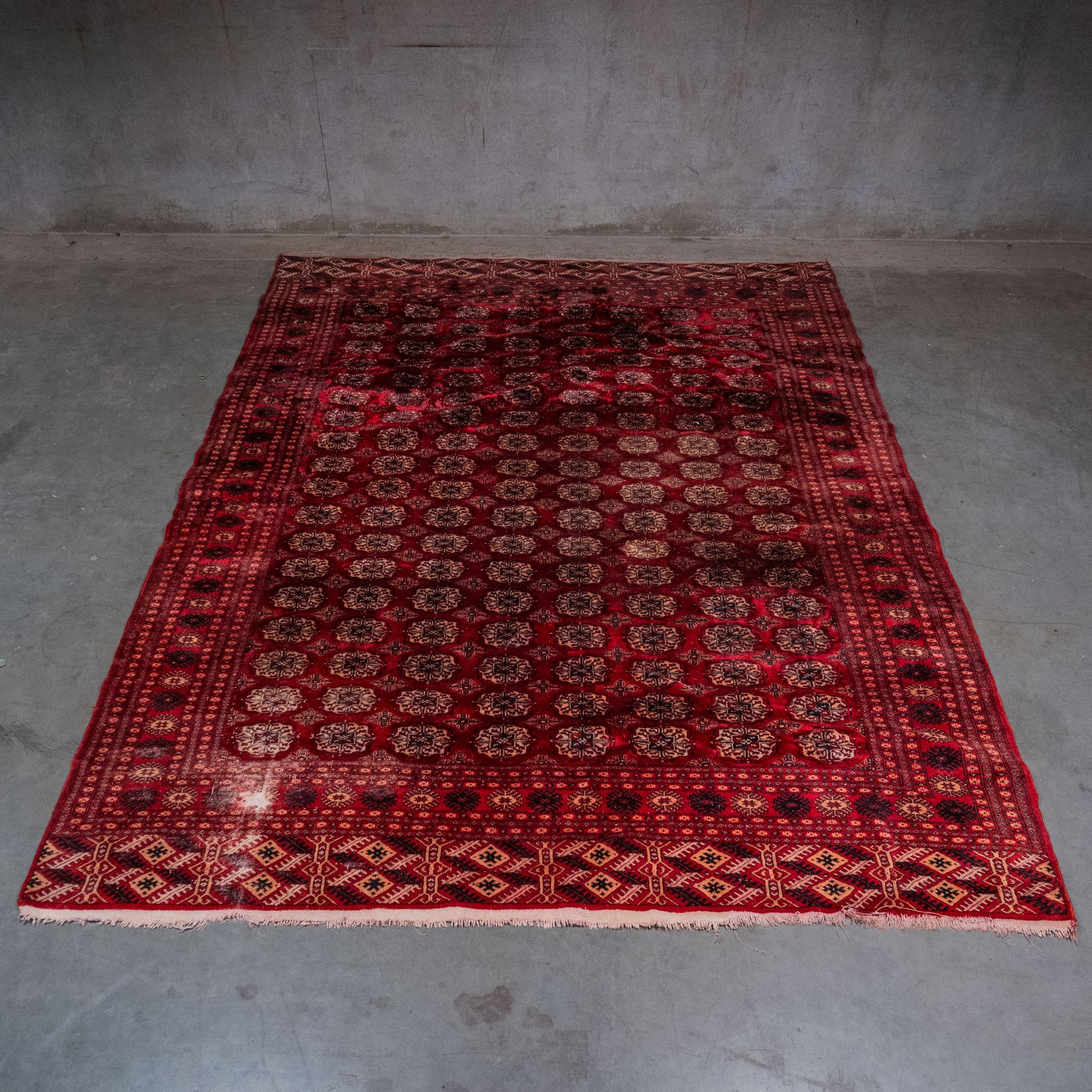 Vintage Turkmen Tekke hand-knotted wool carpet with traditional gul pattern, 9 x 11 feet | Scott Landon Antiques and Interiors.