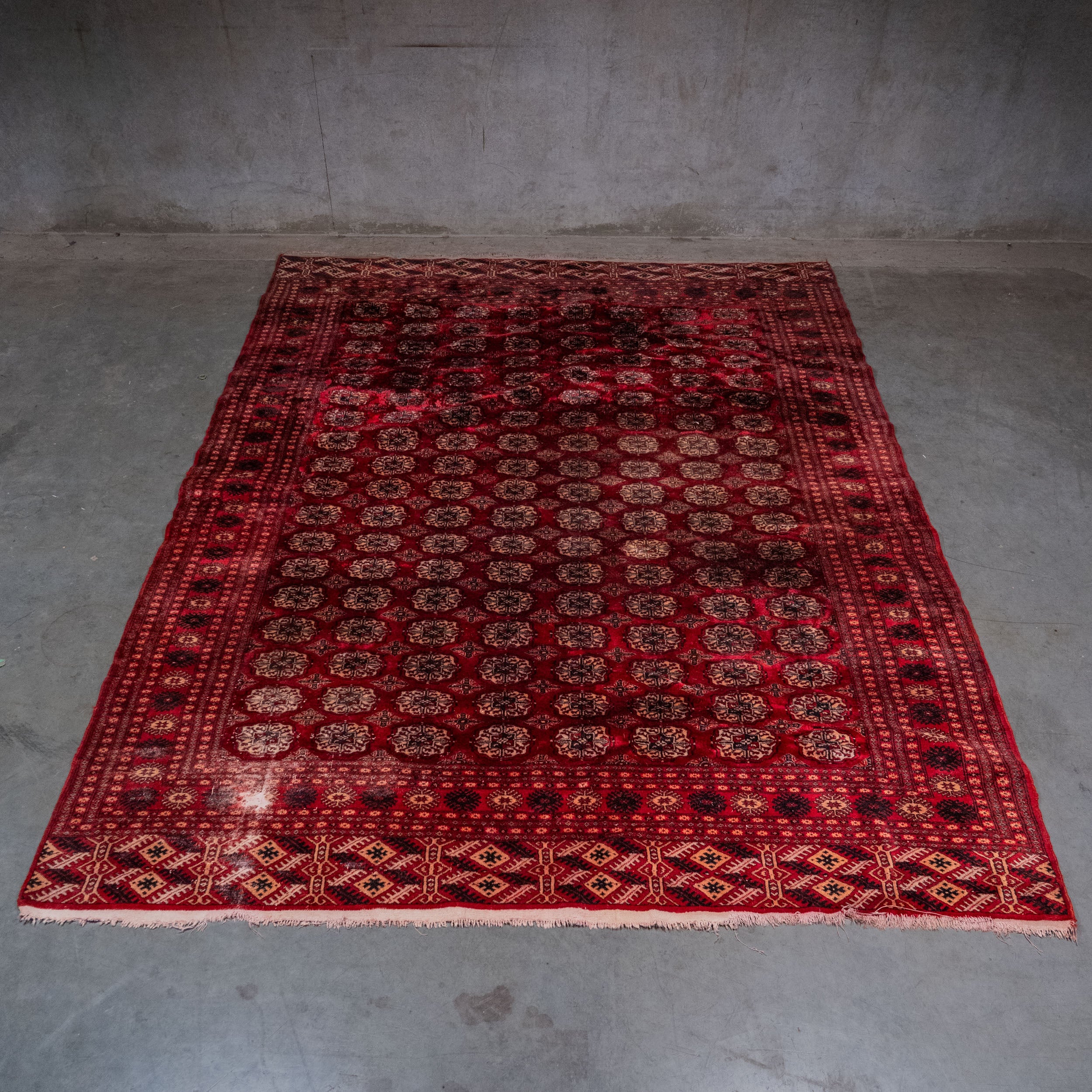 Vintage Turkmen Tekke hand-knotted wool carpet with traditional gul pattern, 9 x 11 feet | Scott Landon Antiques and Interiors.