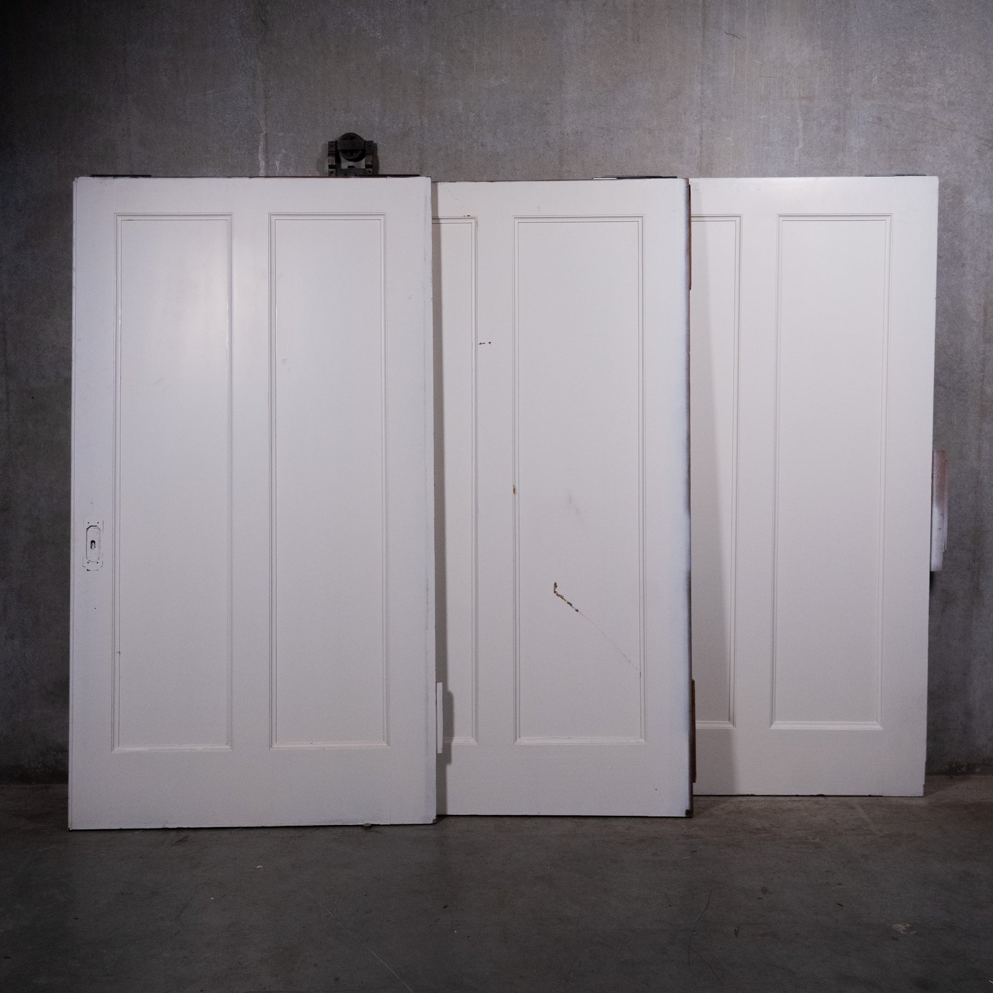 Large antique two-panel wood pocket doors with original hardware circa 1910 | Scott Landon Antiques and Interiors.