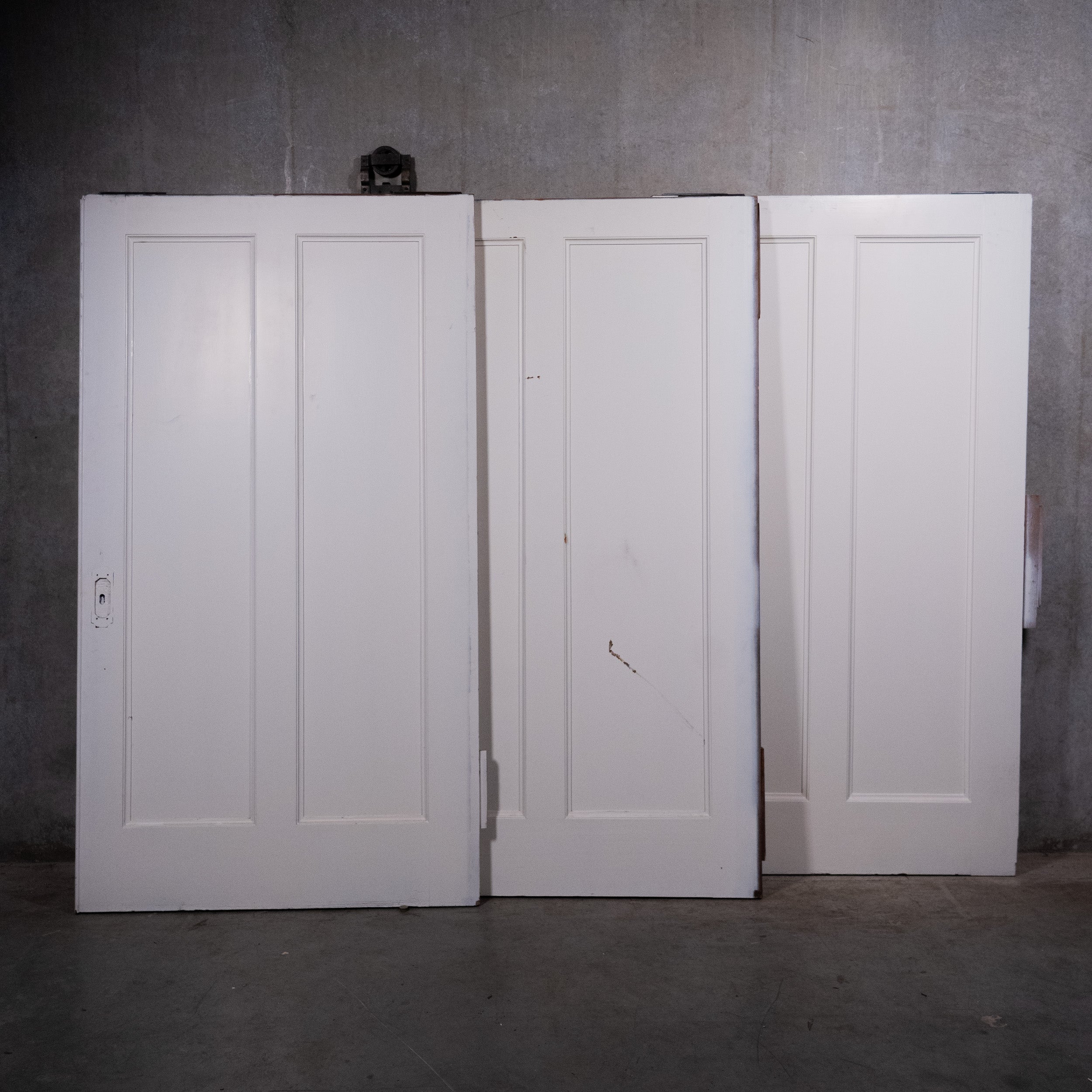 Large antique two-panel wood pocket doors with original hardware circa 1910 | Scott Landon Antiques and Interiors.