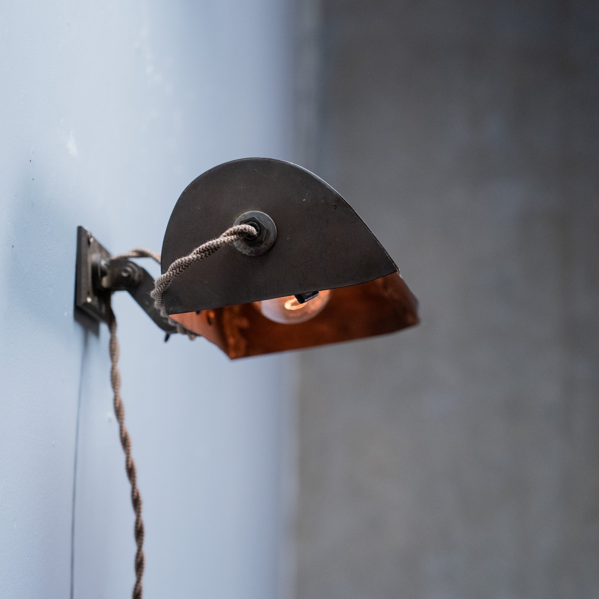 Antique industrial adjustable wall task light with curved metal hood circa 1920s–1 Scott Landon Antiques and Interiors.