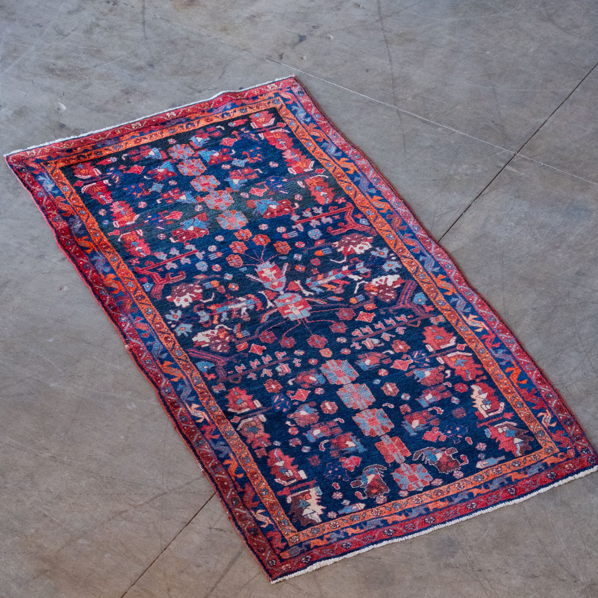 Vintage Hand-Knotted Persian Style Rug – Indigo Field with Red & Orange Tribal Motifs – c. 1970’s