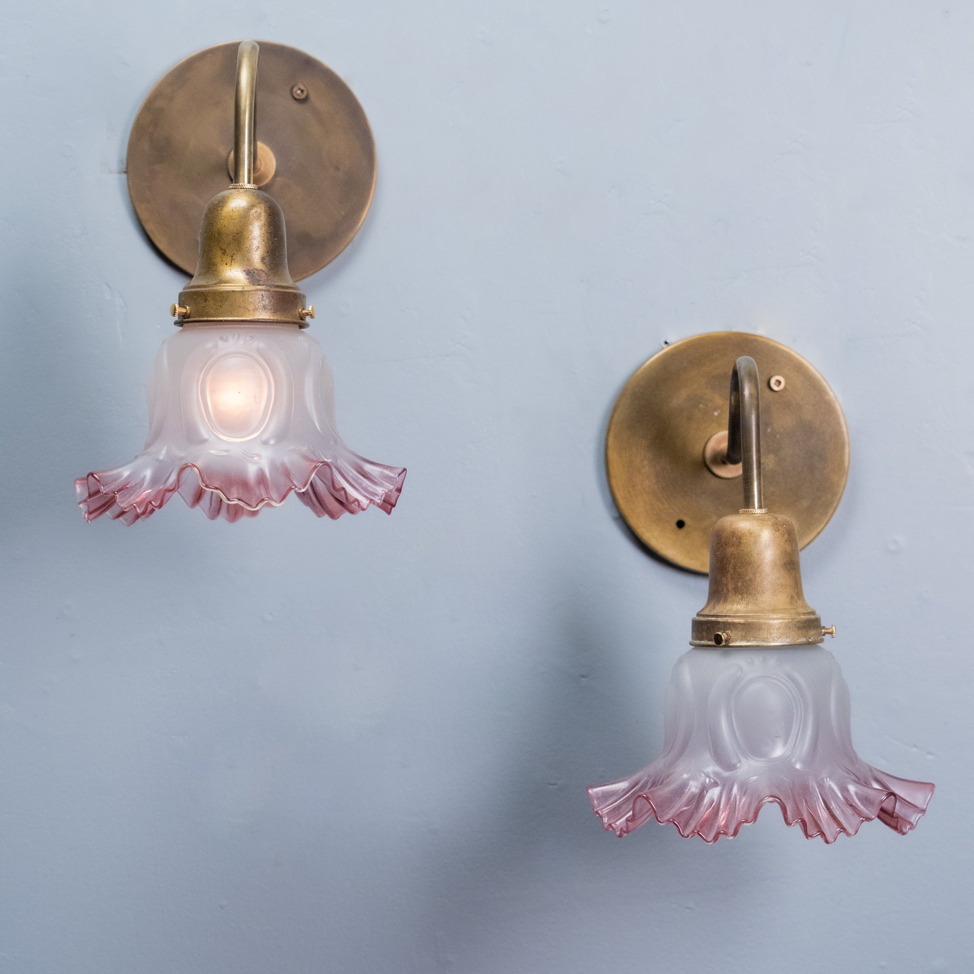Pair antique brass gooseneck wall sconces with pink frosted glass shades circa 1910 | Scott Landon Antiques and Interiors.
