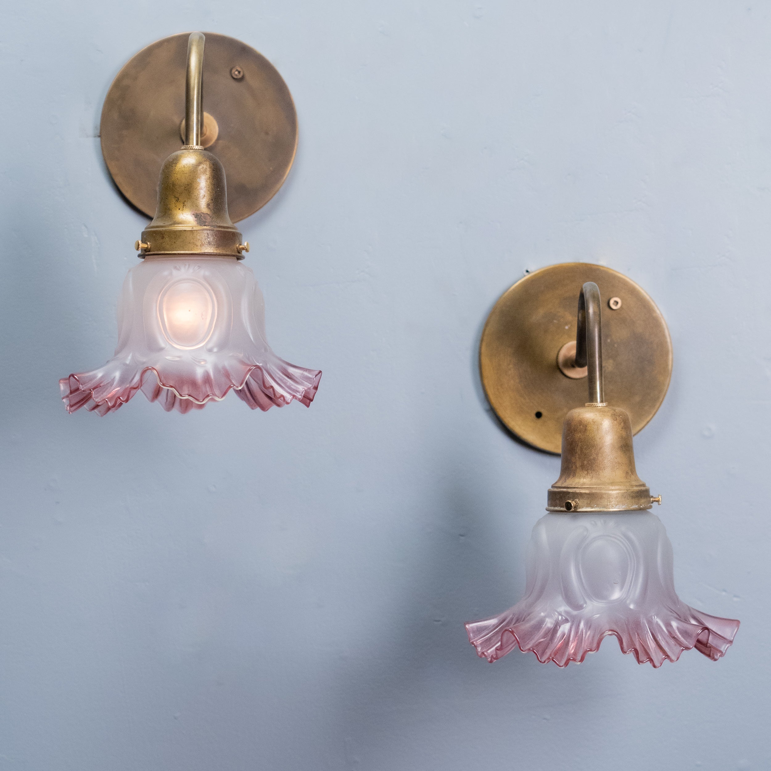 Pair antique brass gooseneck wall sconces with pink frosted glass shades circa 1910 | Scott Landon Antiques and Interiors.