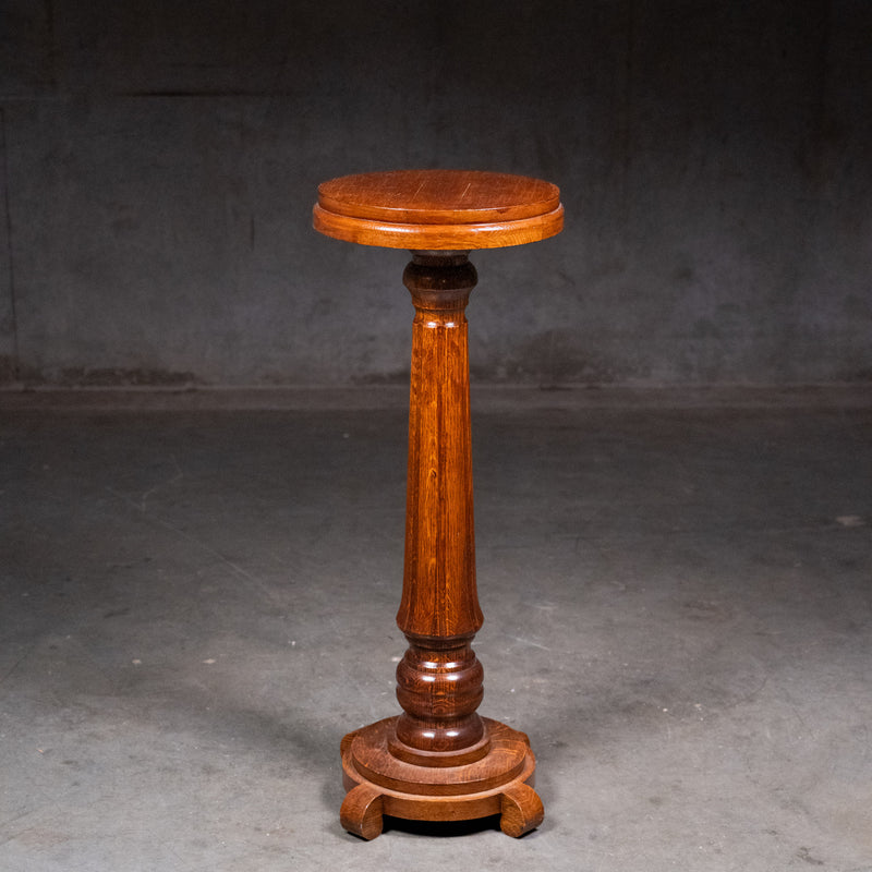 Antique c.1900 quarter-sawn oak pedestal plant stand with figured tapered column, circular top and raised four-foot base | Scott Landon Antiques and Interiors.