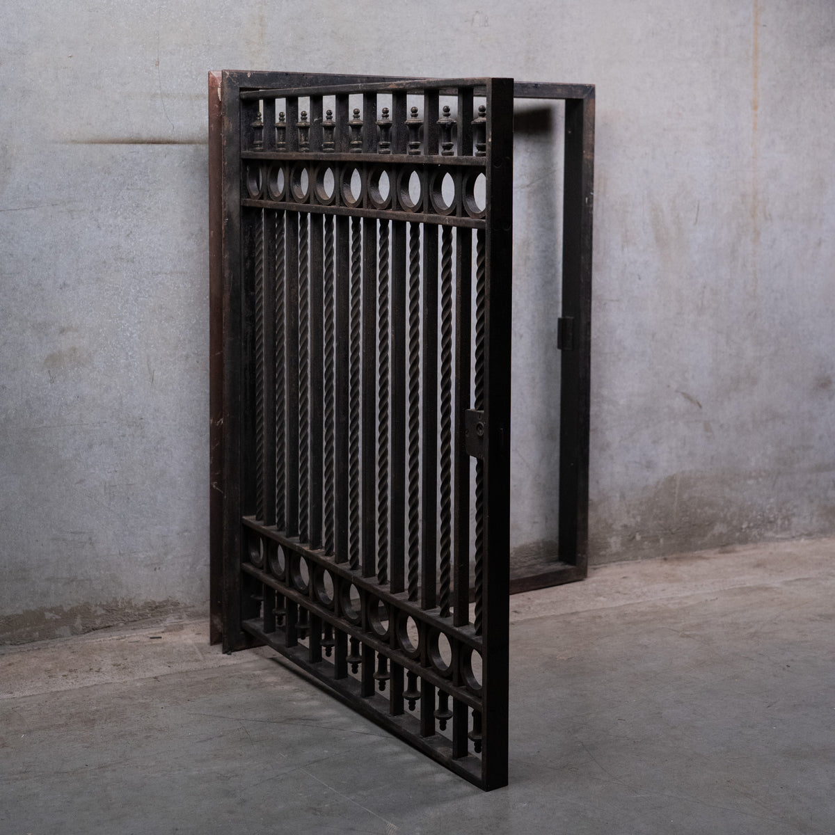  Antique Chicago ornamental iron window guard circa 1910 with hinged frame, twisted bars, circular details and original locking mechanism. | Scott Landon Antiques and Interiors.
