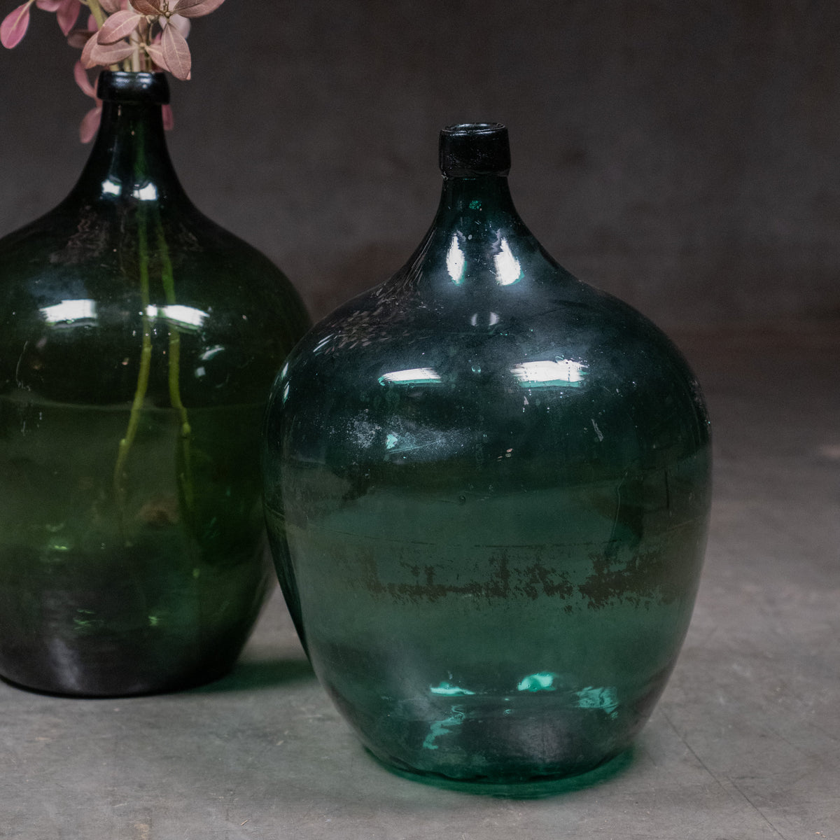 Large 23-inch olive-green blown-glass carboy with rounded body and short narrow neck. | Scott Landon Antiques and Interiors.
