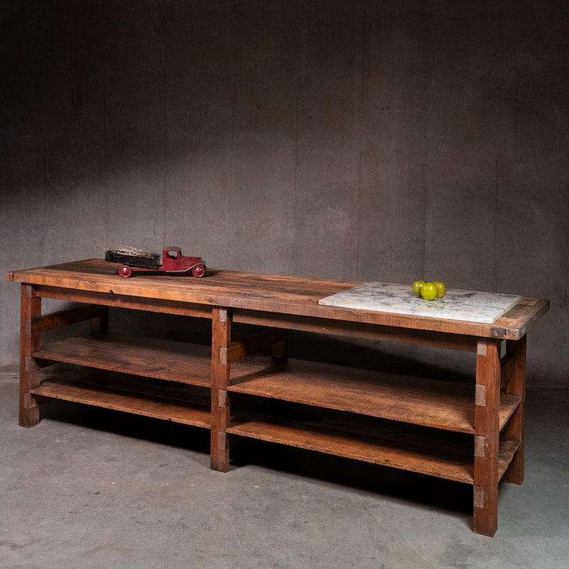 Large vintage wooden grocer’s worktable from Tosi Italian Food Imports in Vancouver, with plank top and two lower shelves. | Scott Landon Antiques and Interiors.