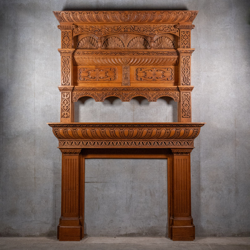 Monumental Victorian Renaissance Revival oak fireplace mantel dated 1893 with hand-carved Gothic arches and architectural overmantel
