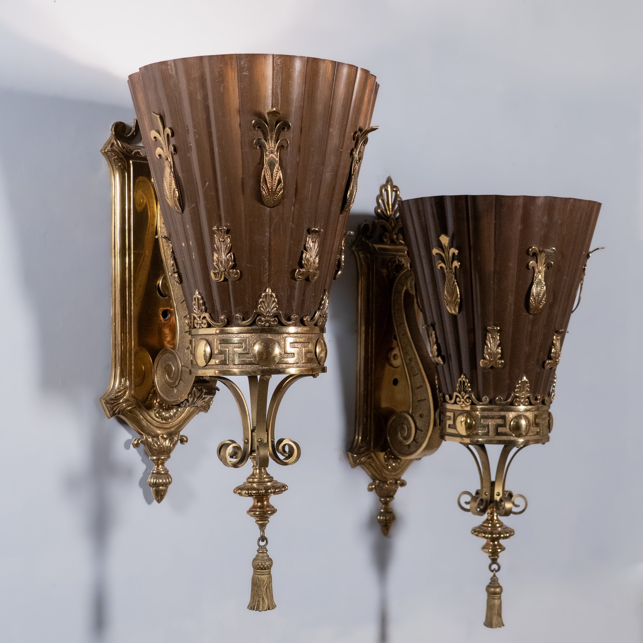 Set of four monumental Beaux-Arts bronze and copper wall sconces from a historic Montreal banking hall with torch-form shades and classical detailing