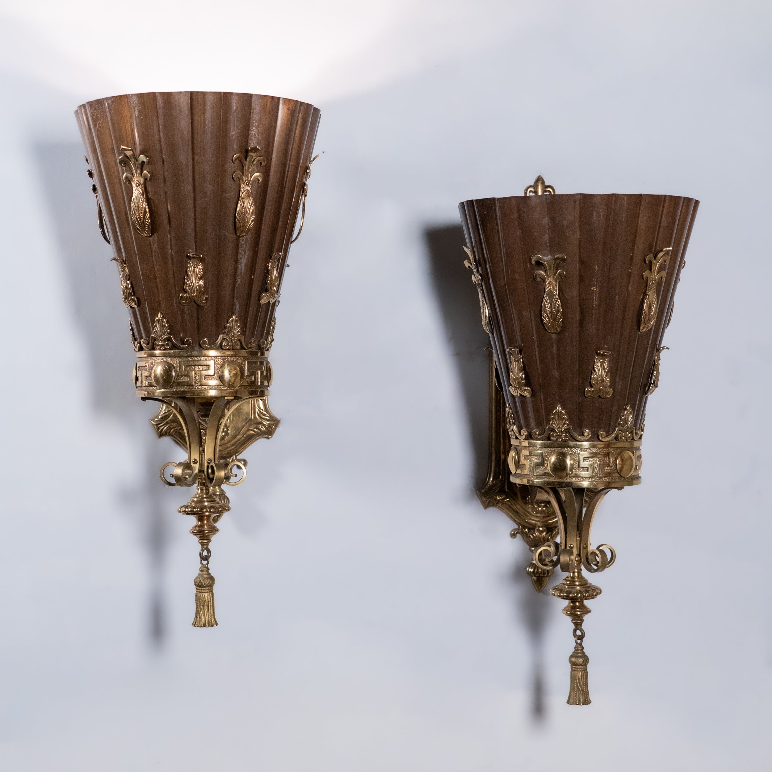 Set of four monumental Beaux-Arts bronze and copper wall sconces from a historic Montreal banking hall with torch-form shades and classical detailing
