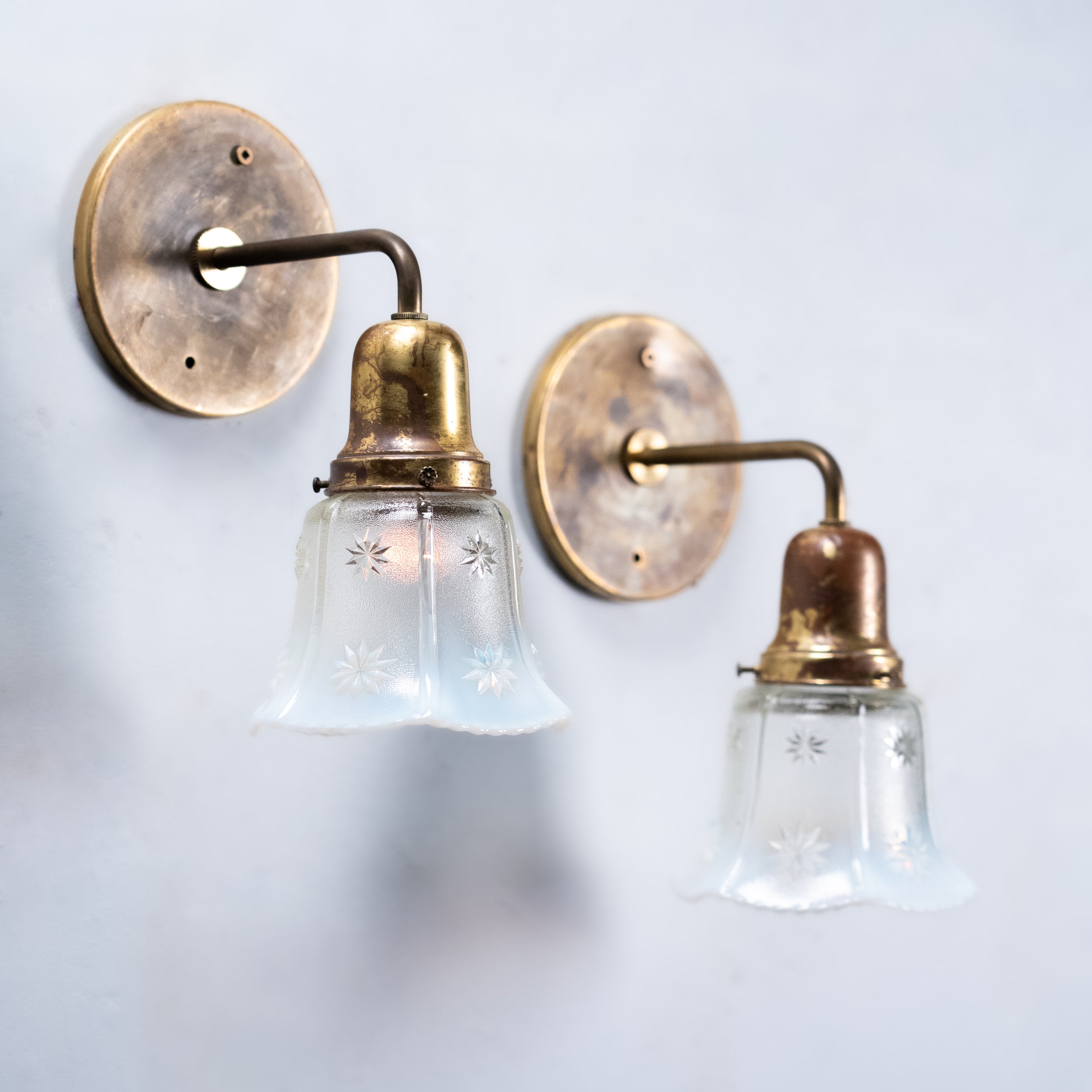 Pair of antique Edwardian brass wall sconces with original opalescent starburst glass shades and aged brass finish, circa 1915 | Scott Landon Antiques and Interiors.