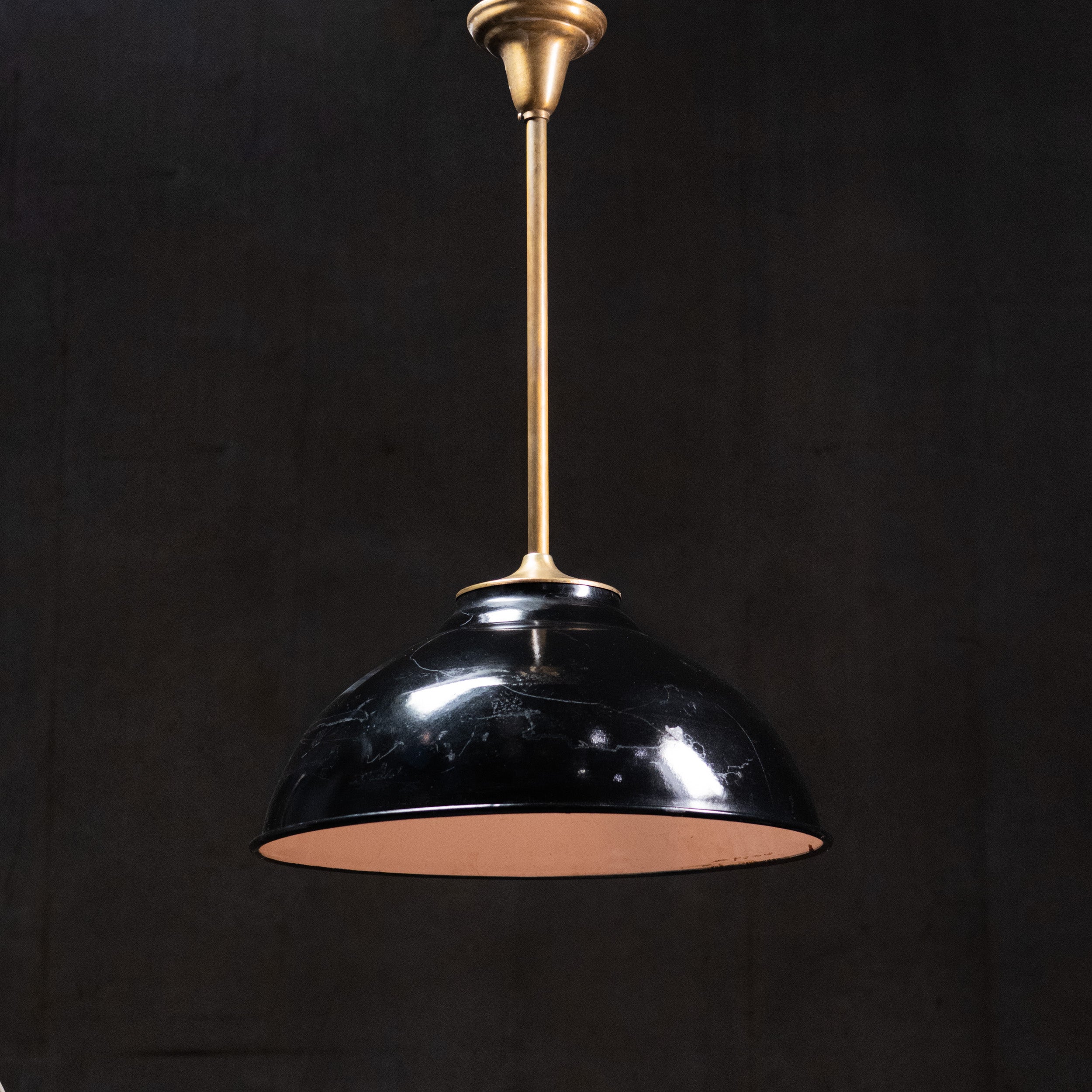 Scandinavian Modern black enamel pendant light with brass stem and white enamel interior, circa 1950