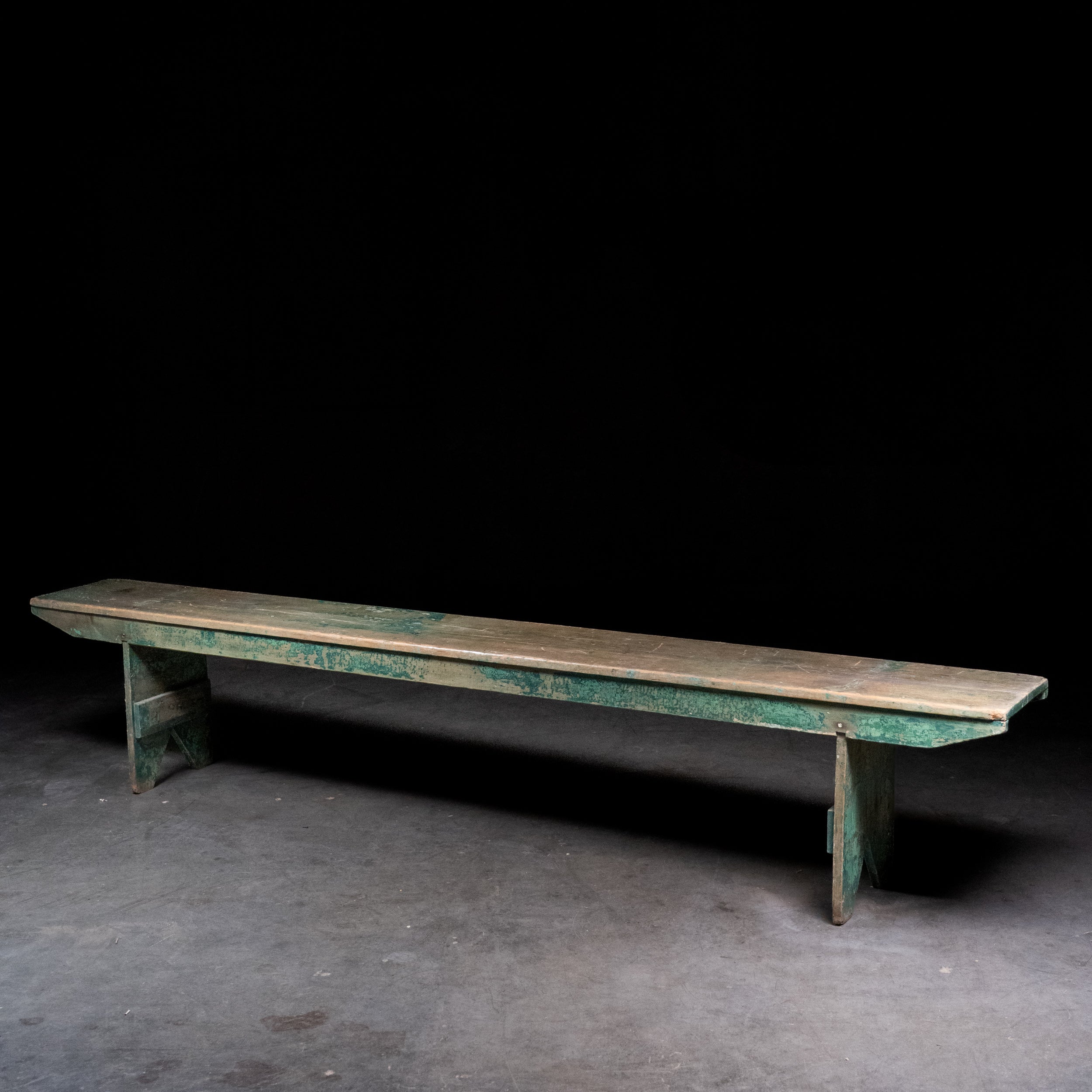 Antique 8 foot painted pine bench with original green paint and primitive trestle base, circa 1900
