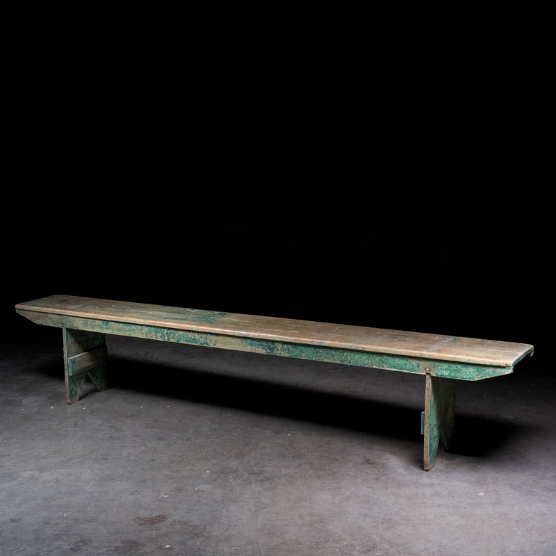 Antique 8 foot painted pine bench with original green paint and primitive trestle base, circa 1900
