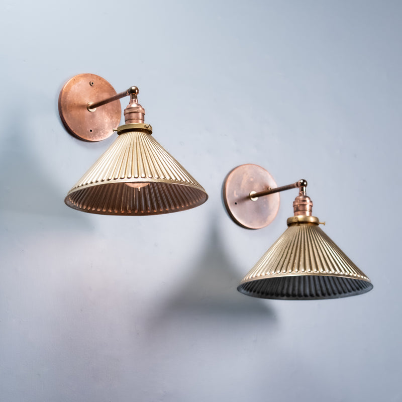 Pair of Art Deco mercury glass wall sconces with ribbed silvered glass shades and aged copper hardware, circa 1930
