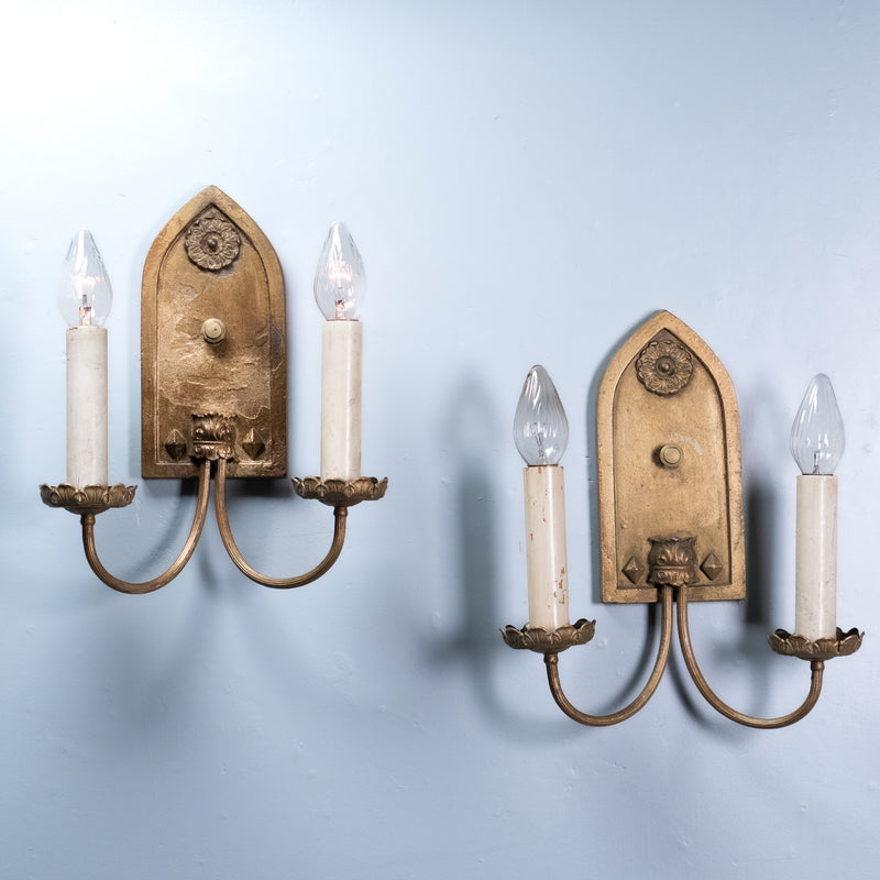 Antique Gothic Revival double arm wall sconce with gilt finish and pointed arch backplate, circa 1930.
