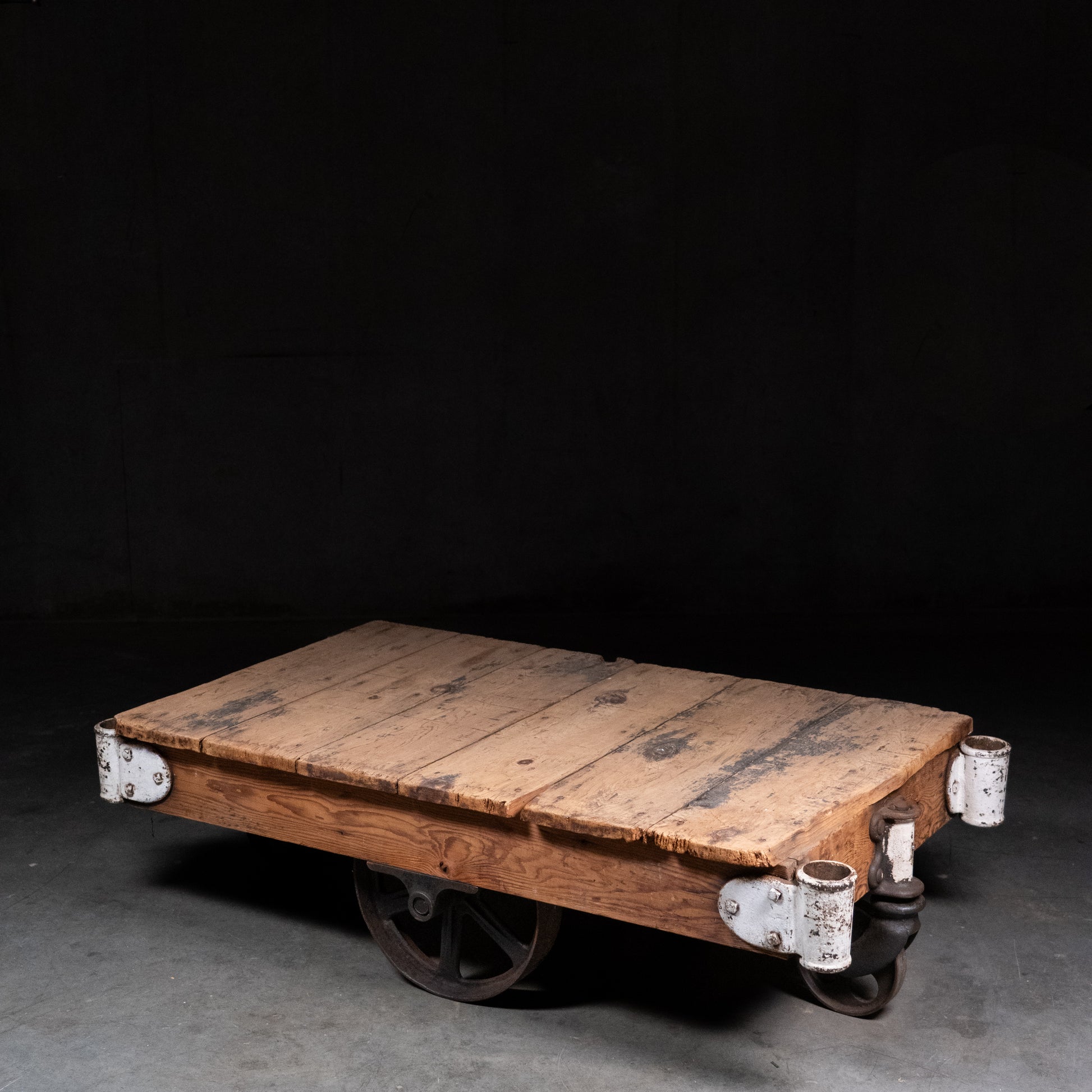 Antique industrial factory cart with original pine plank top, cast iron wheels, steel hardware and warehouse patina, early twentieth centur | Scott Landon Antiques and Interiors.