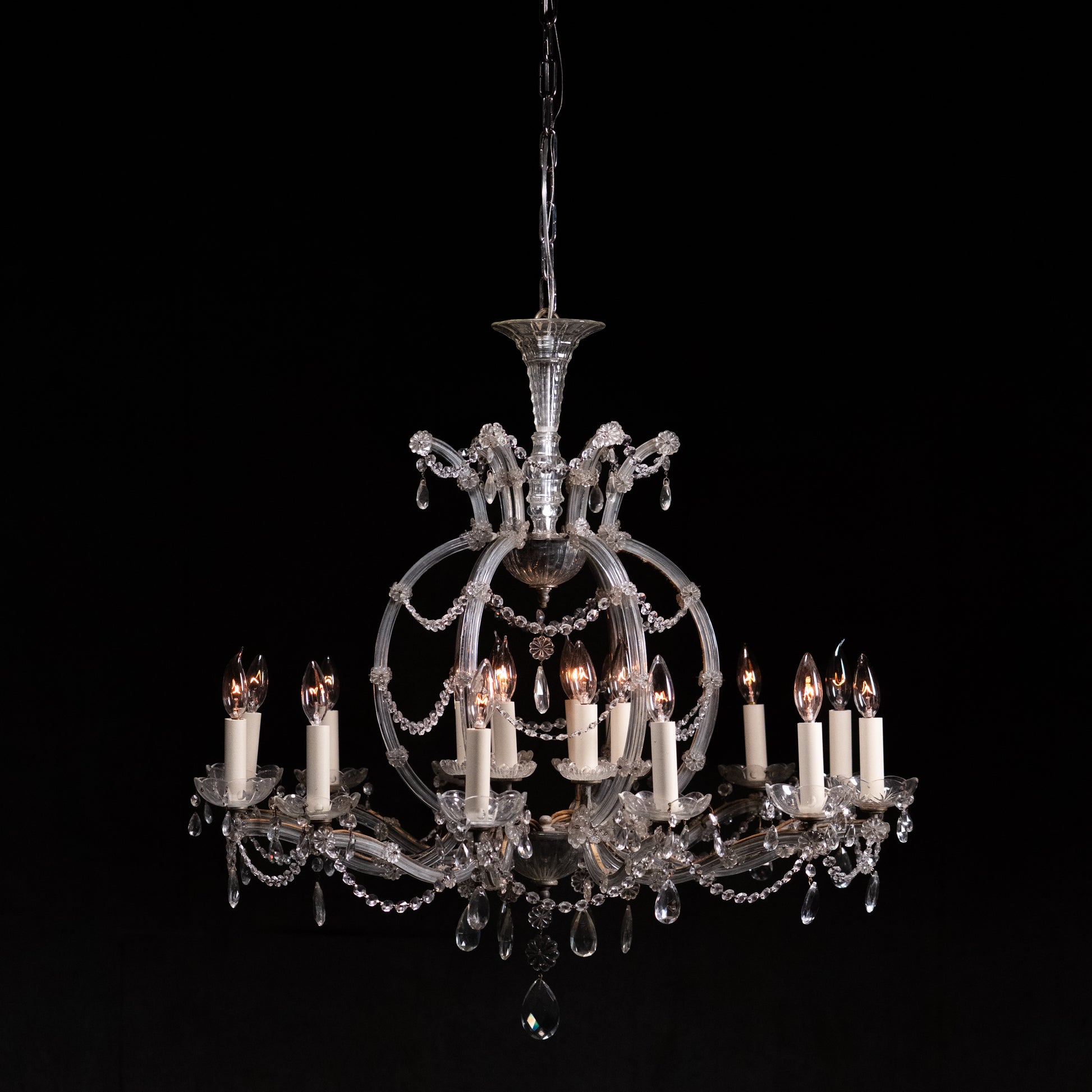 Large Venetian style glass and crystal chandelier with ribbed glass arms, floral rosettes, crystal swags and faceted pendalogues, mid-century European. | Scott Landon Antiques and Interiors.