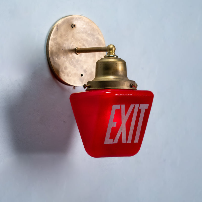 Vintage red EXIT glass wall sconce with handcrafted solid brass mount made from reclaimed theatre architectural salvage.