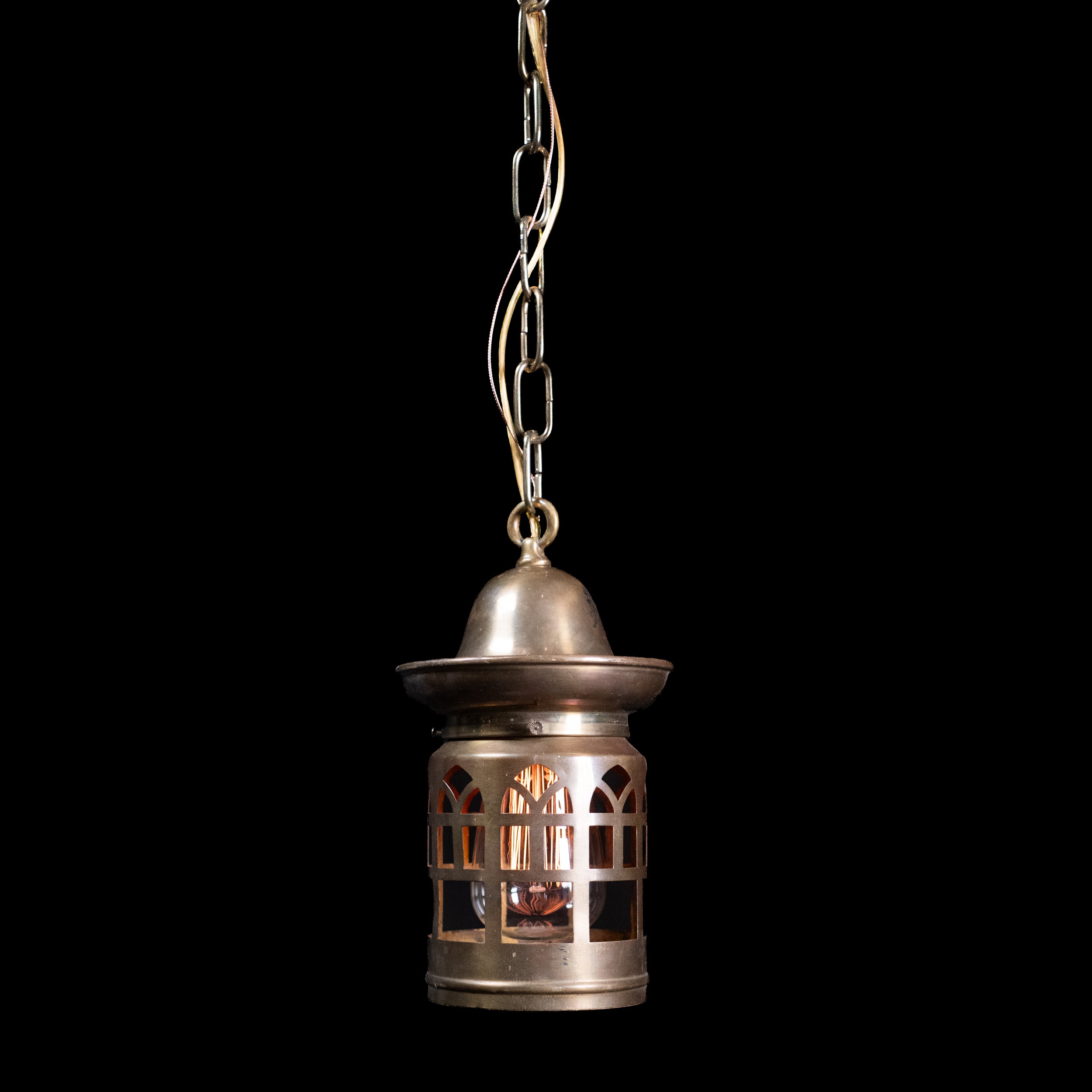 Early 20th-century antique brass lantern pendant with pierced Gothic-style window detailing.
