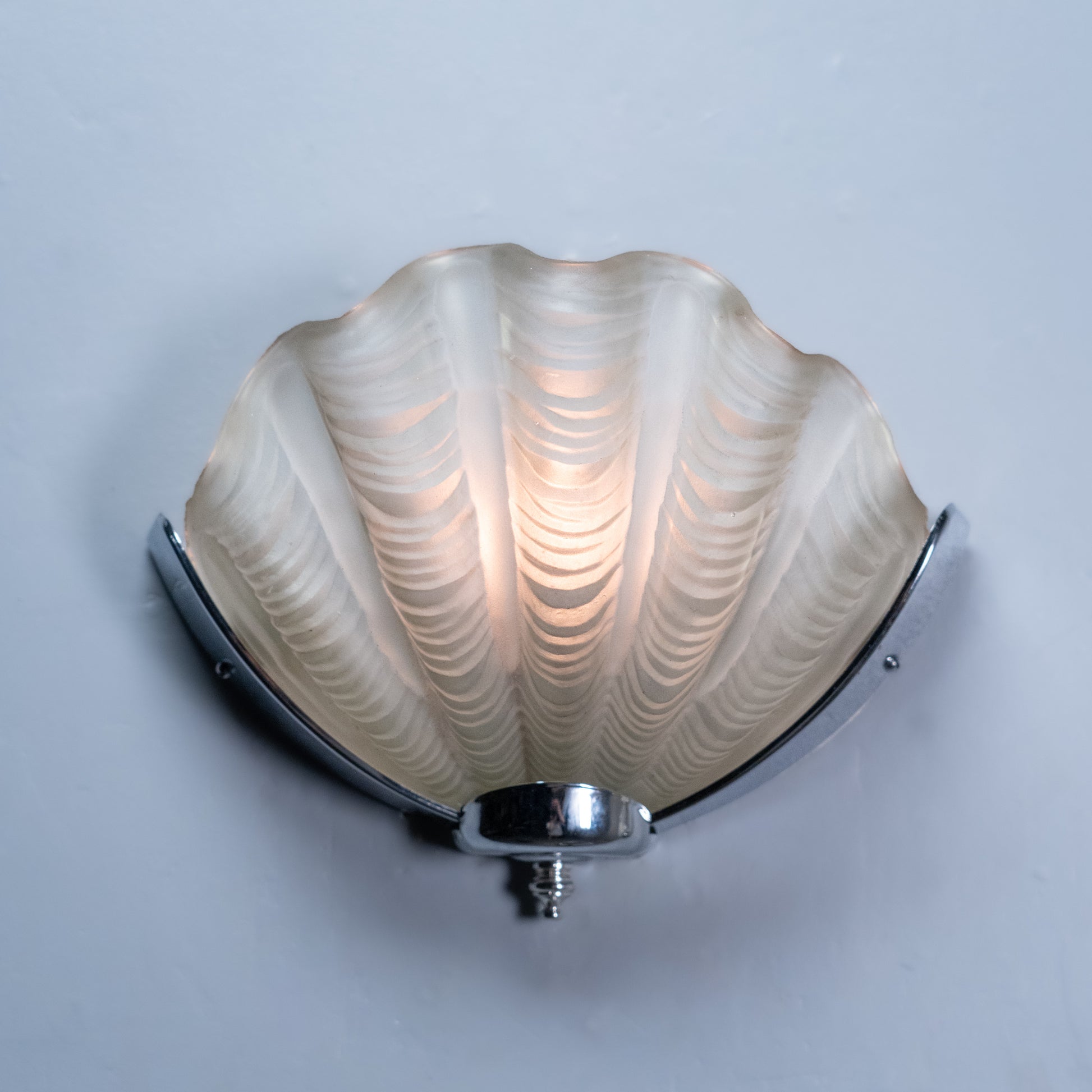Pair of Italian Art Deco shell-form wall sconces with molded frosted glass shades and polished chrome mounts, circa 1935. | Scott Landon Antiques and Interiors.