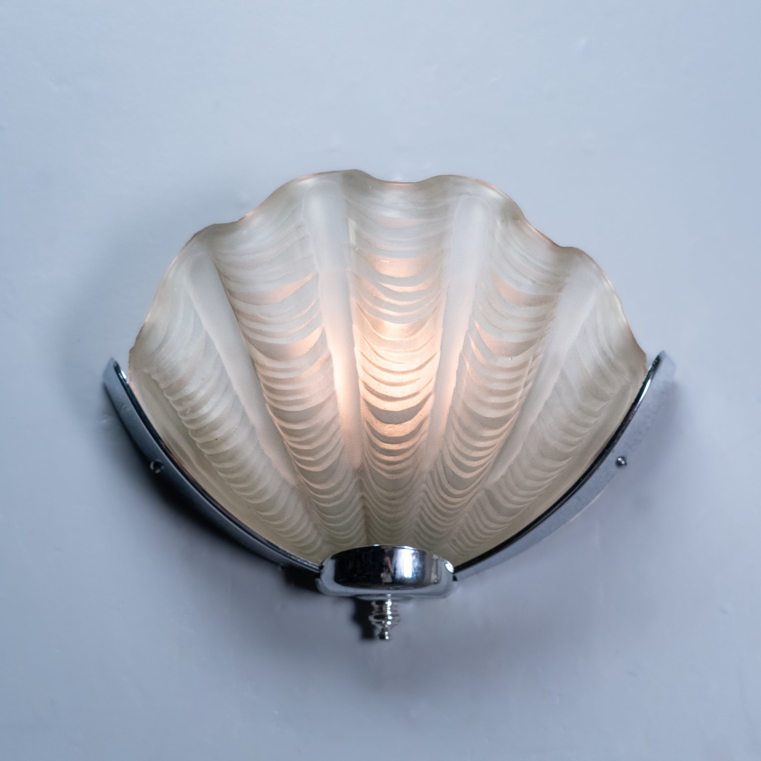 Pair of Italian Art Deco shell-form wall sconces with molded frosted glass shades and polished chrome mounts, circa 1935. | Scott Landon Antiques and Interiors.
