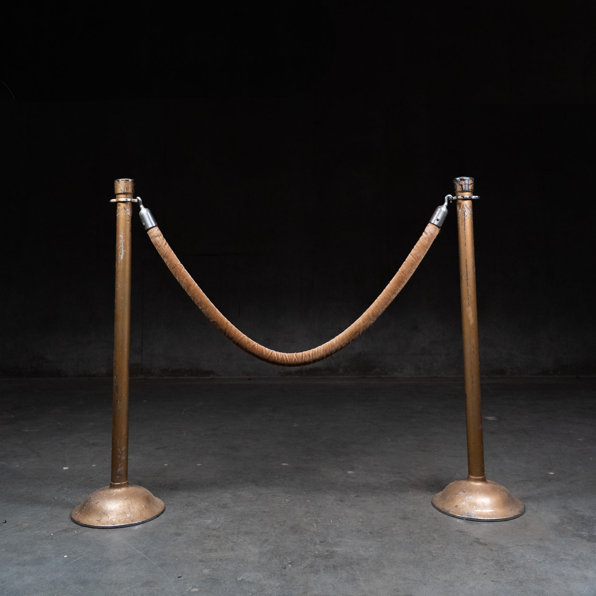 Pair of vintage steel stanchions with original velvet rope used in theatres and banks.