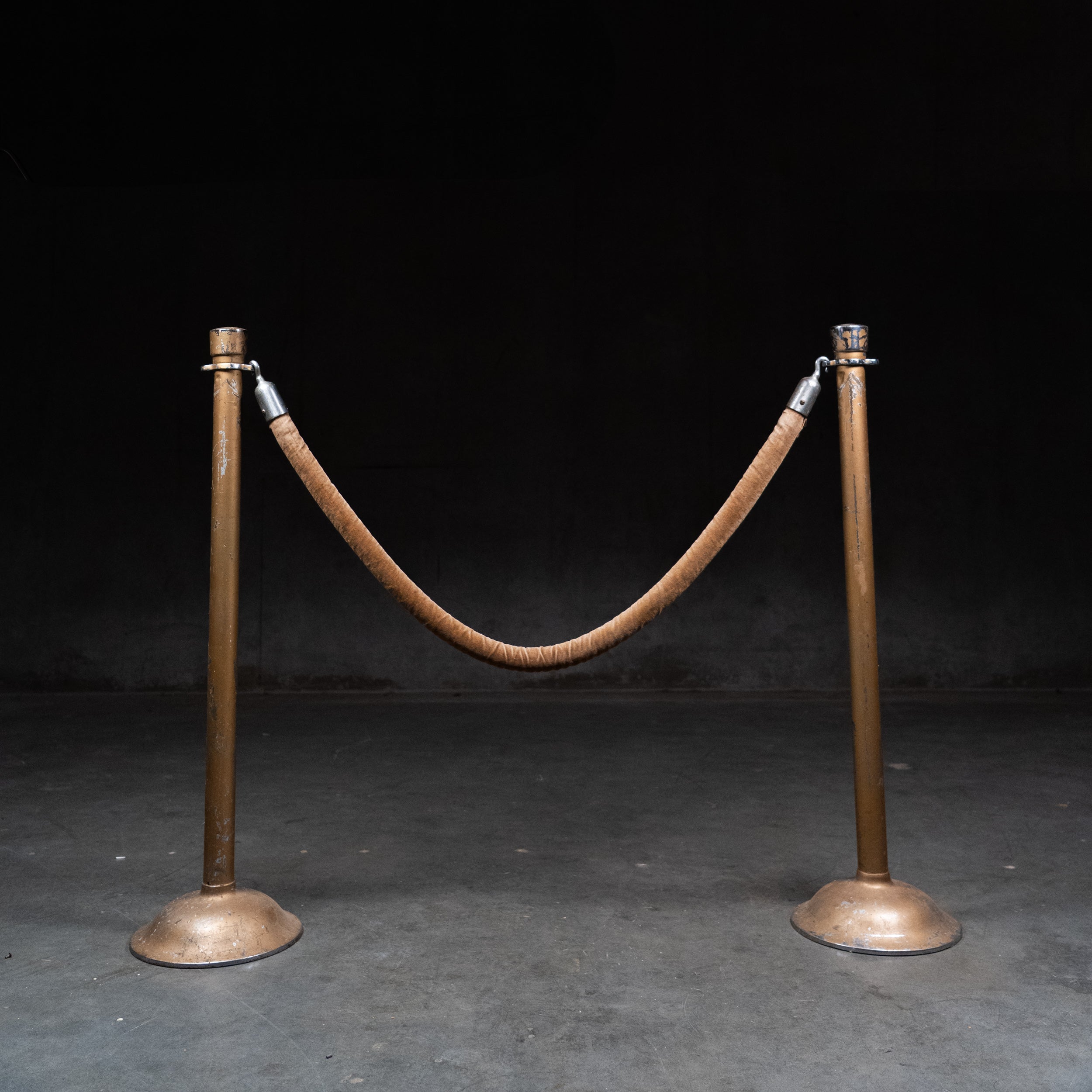 Pair of vintage steel stanchions with original velvet rope used in theatres and banks.