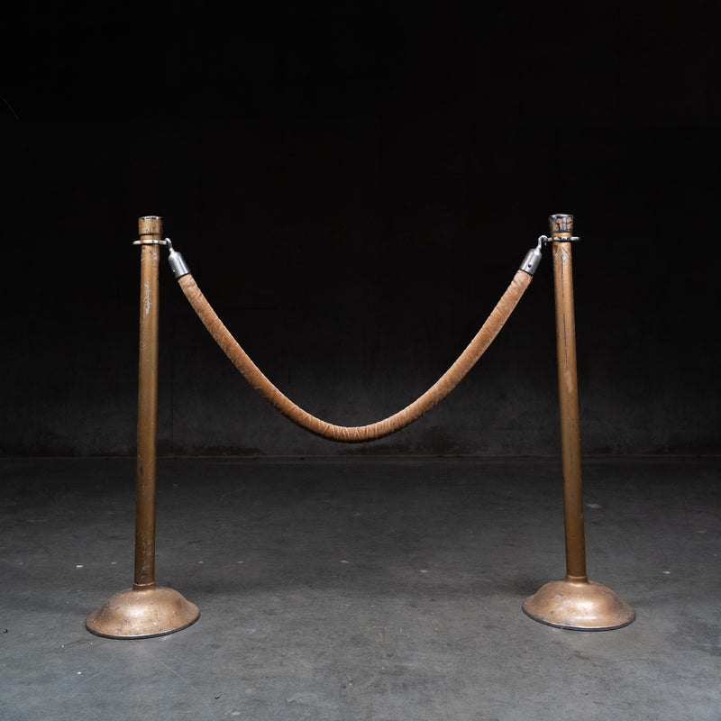 Pair of vintage steel stanchions with original velvet rope used in theatres and banks.