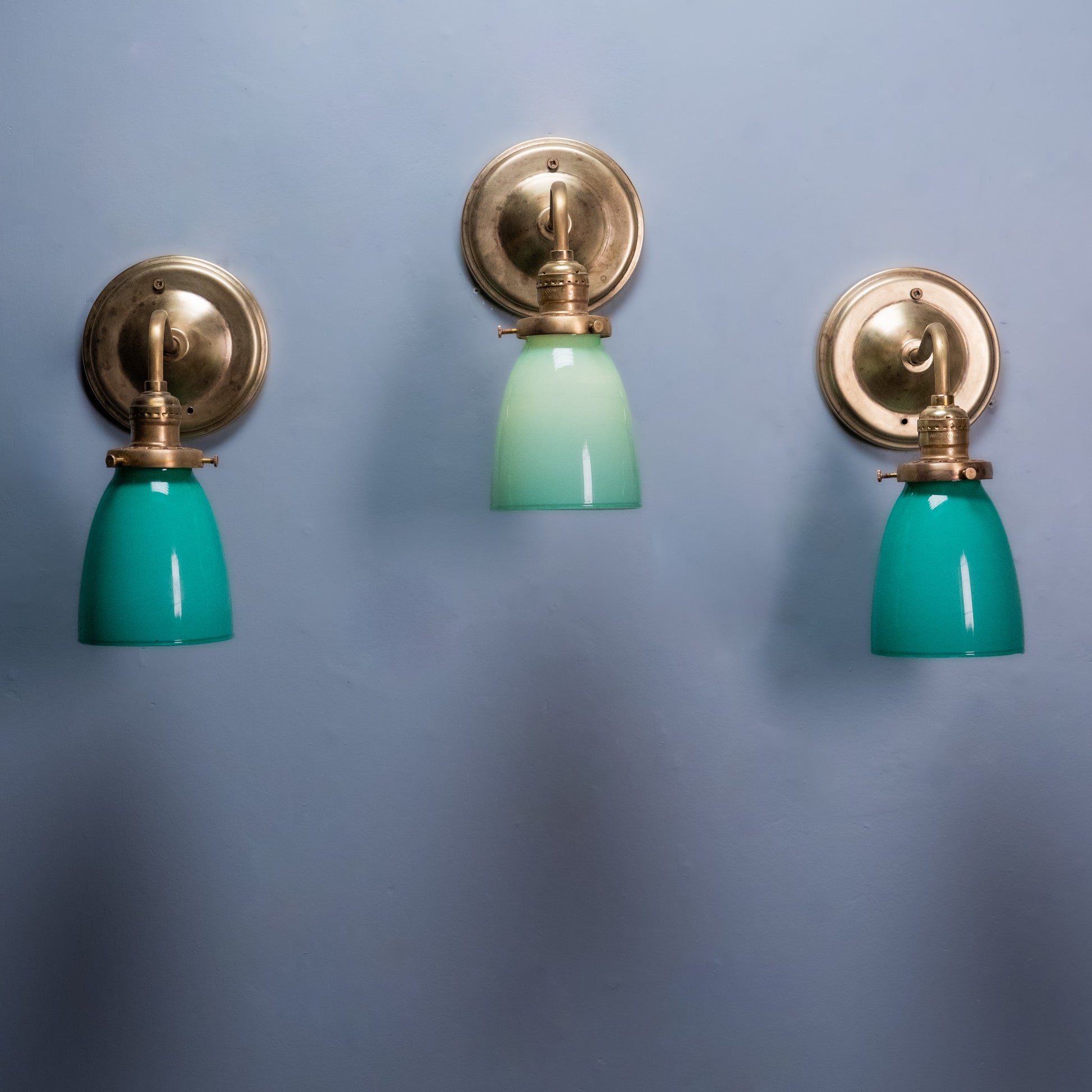 Antique brass wall sconce with green opaline glass shade, Art Deco vintage wall light.