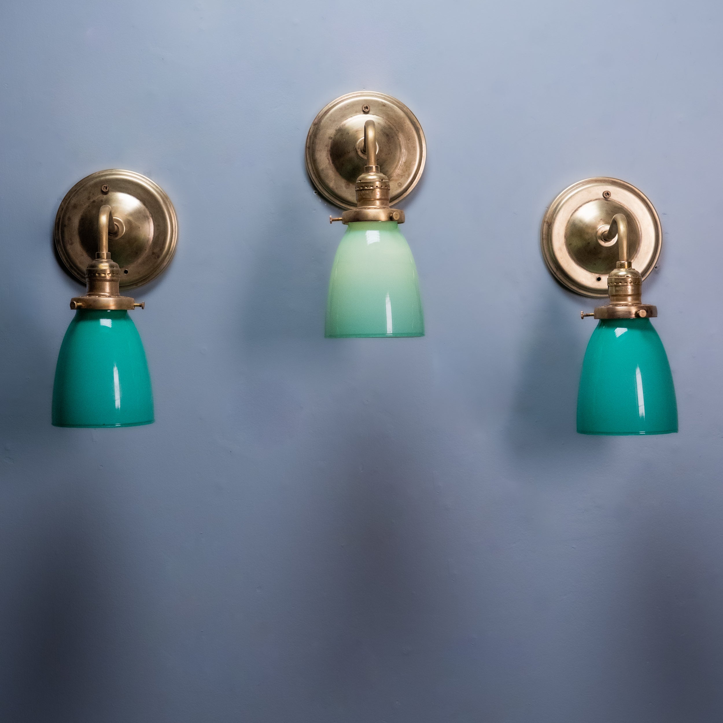 Antique brass wall sconce with green opaline glass shade, Art Deco vintage wall light.