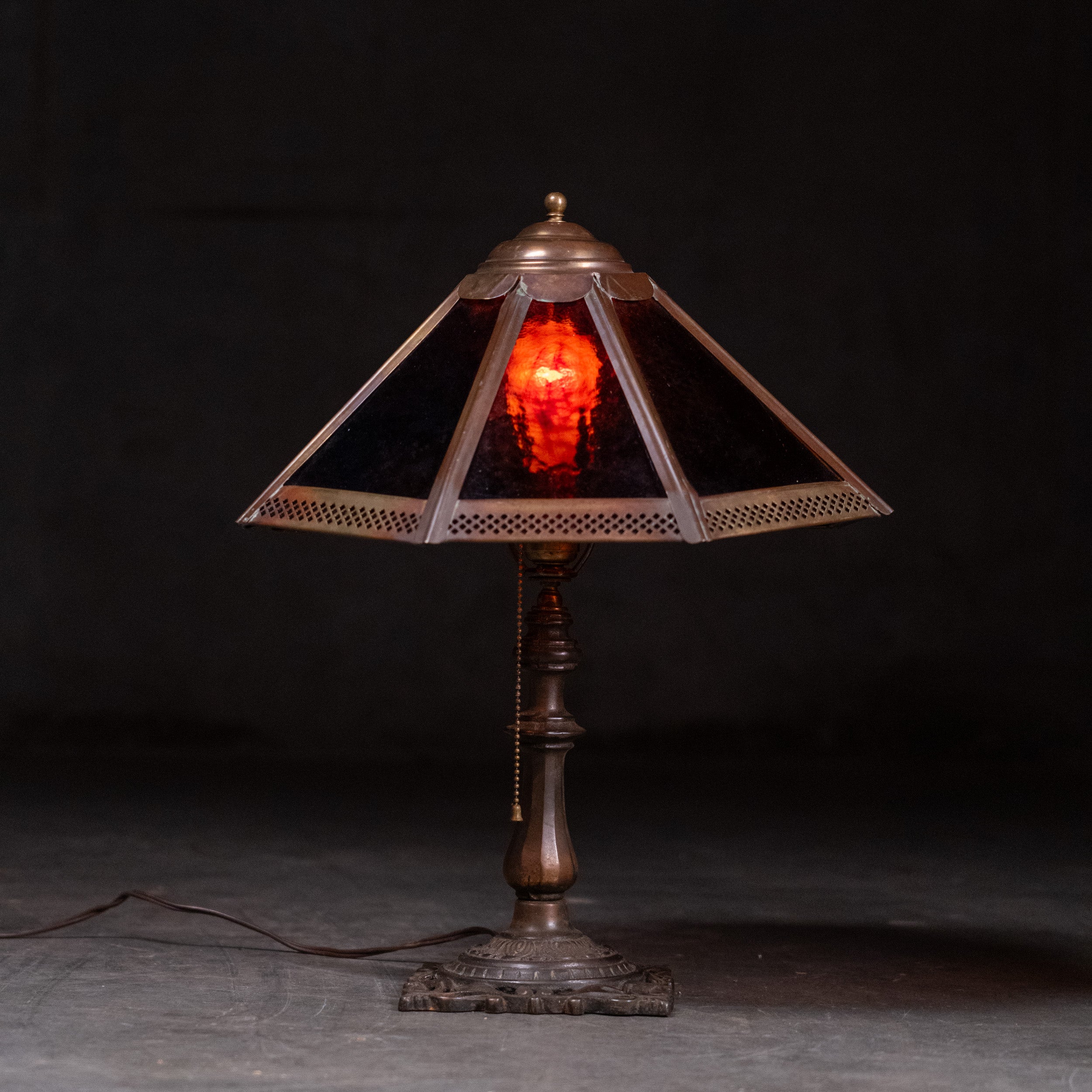 Antique Arts and Crafts table lamp with red slag glass shade and cast metal base circa 1910 | Scott Landon Antiques and Interiors.