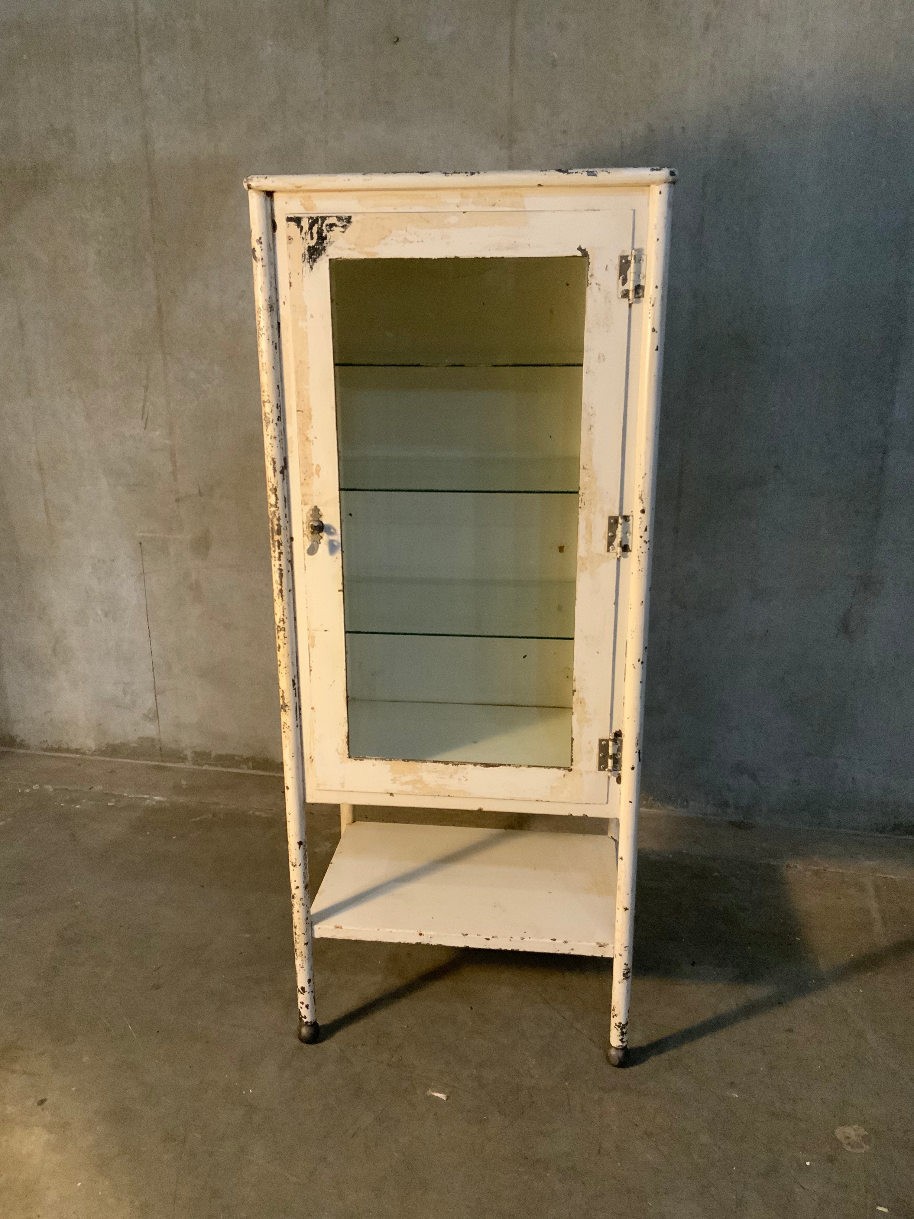 1920  glass door medical cabinet in old finish | Scott Landon Antiques and Interiors.