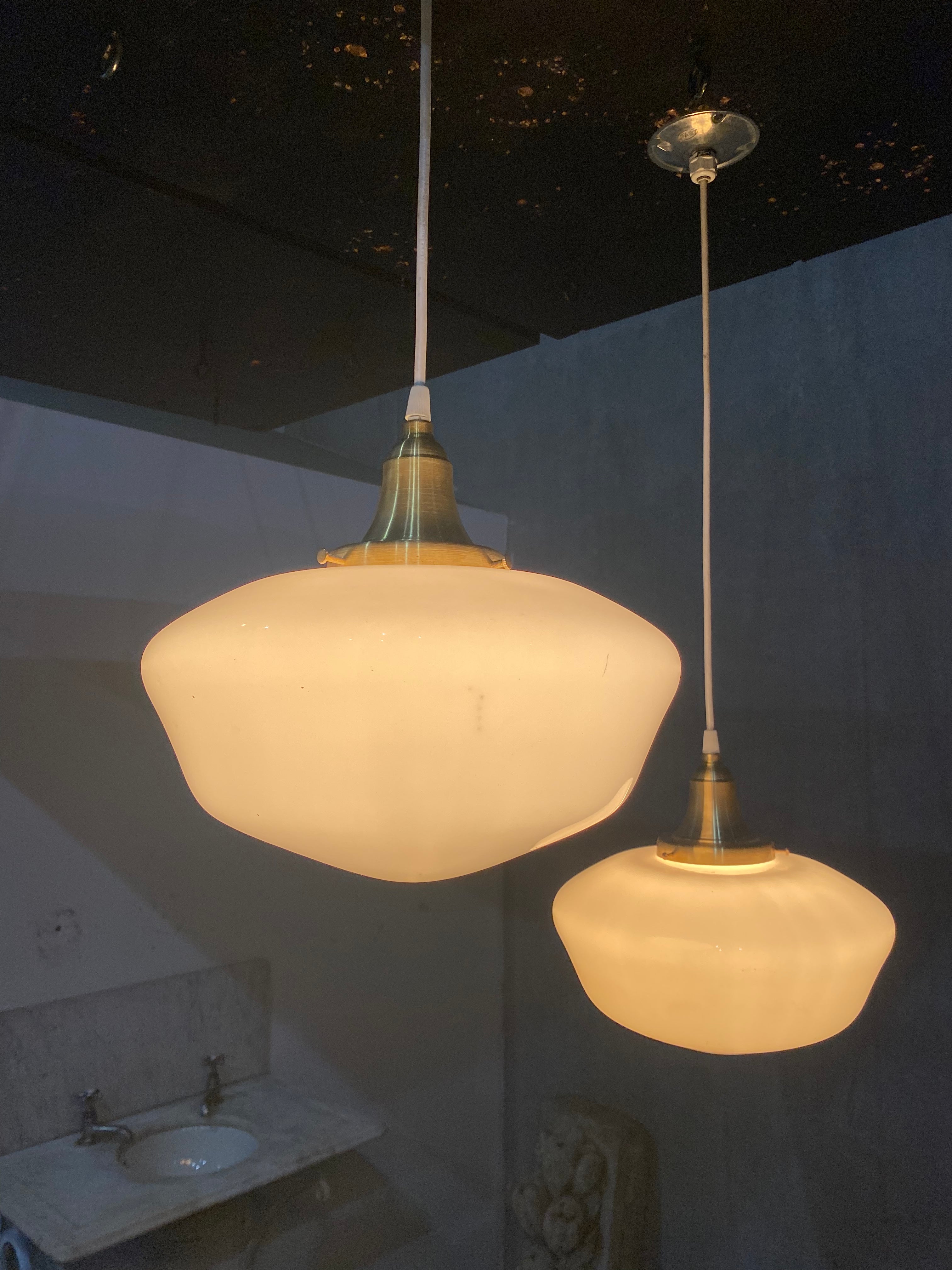 1920  school house milk glass pendant lights on brass fitter | Scott Landon Antiques and Interiors.