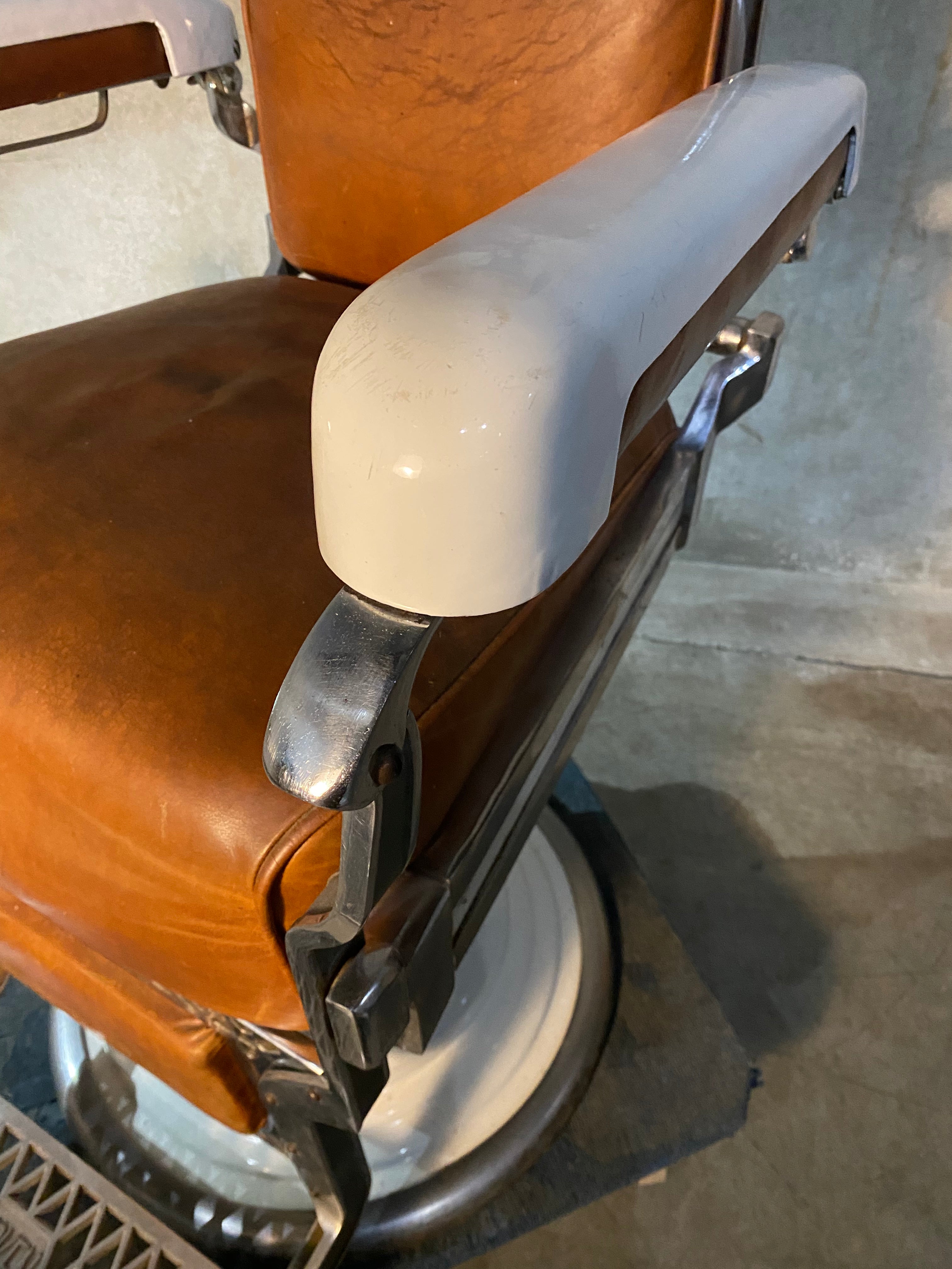 Koken first generation Porcelain barber chair  in old Leather | Scott Landon Antiques and Interiors.