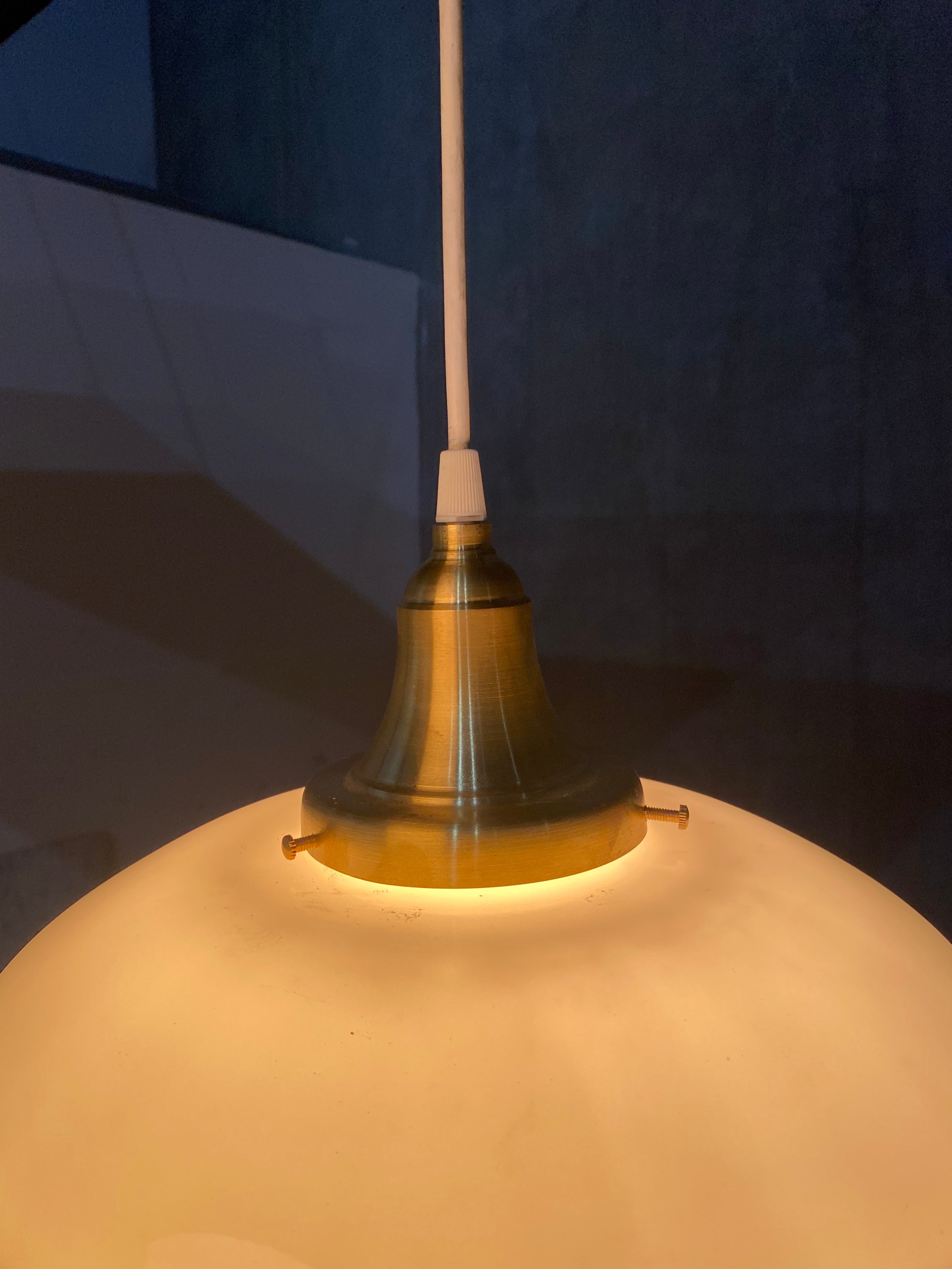 1920  school house milk glass pendant lights on brass fitter | Scott Landon Antiques and Interiors.