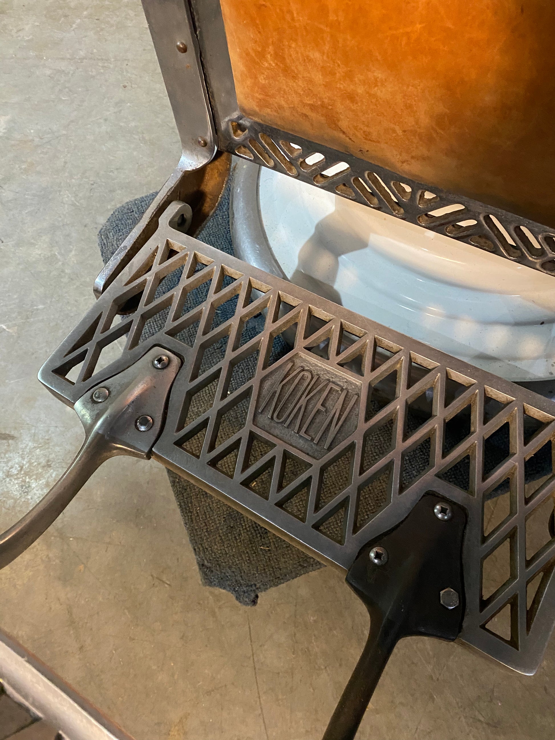 Koken first generation Porcelain barber chair  in old Leather | Scott Landon Antiques and Interiors.