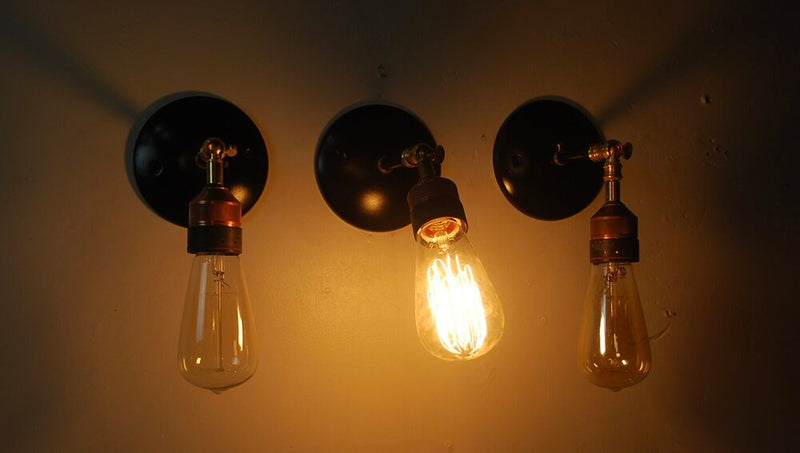 Set of three articulating copper / brass wall sconces | Scott Landon Antiques and Interiors.