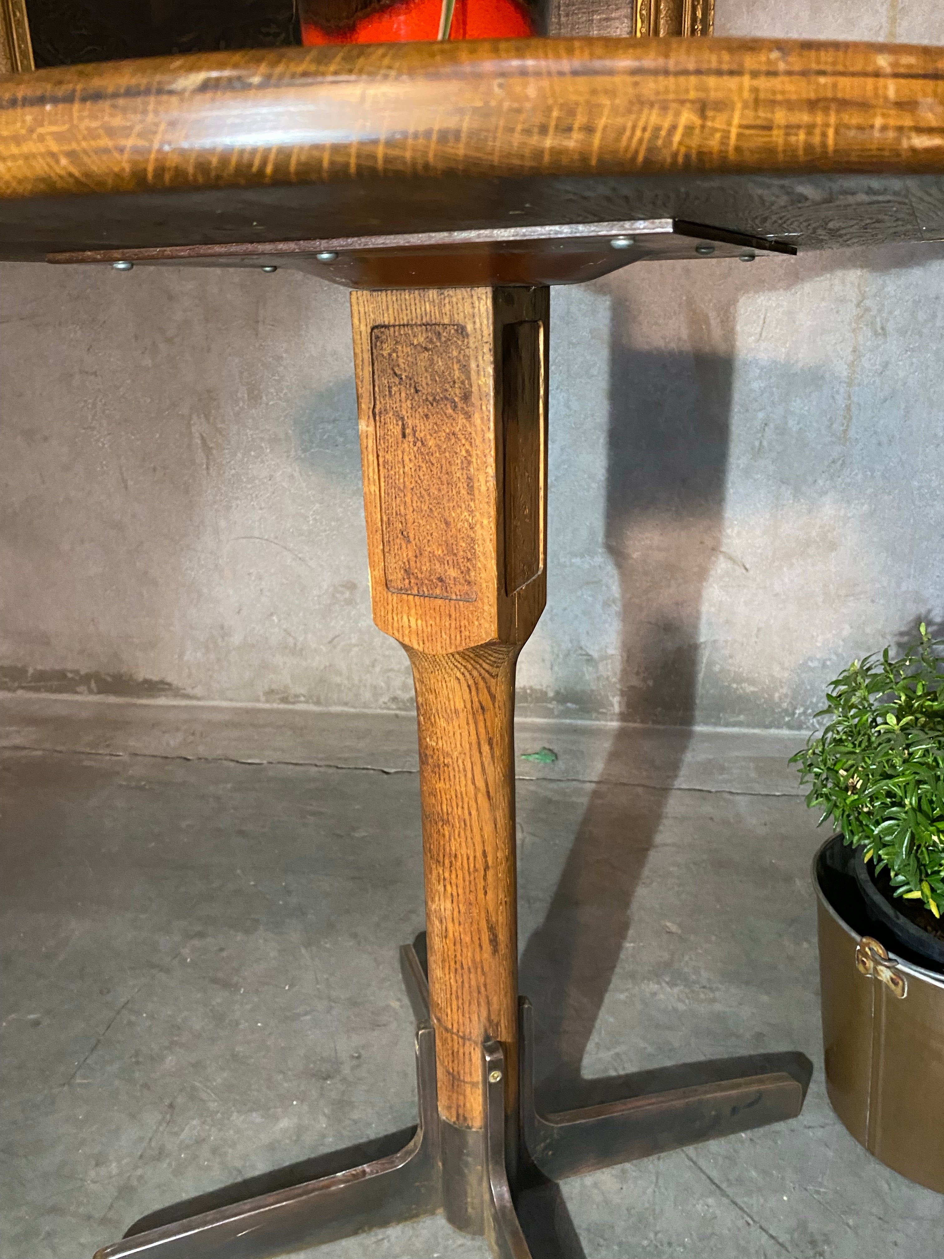 1940 oak pub table with cast iron base | Scott Landon Antiques and Interiors.